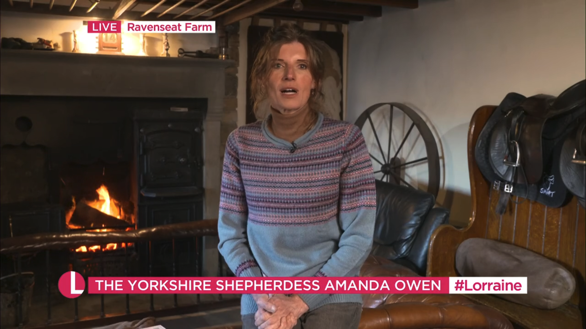 Amanda Owen sitting in front of a fire on her farm