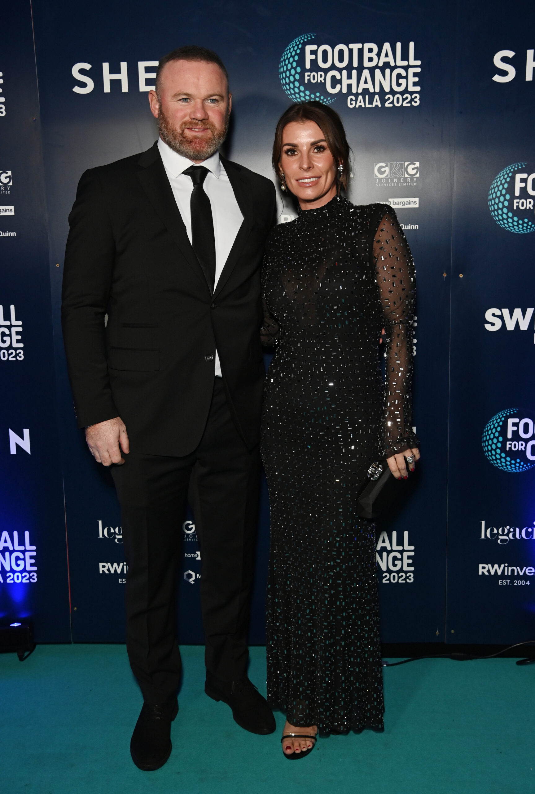 Wayne Rooney and wife Coleen wearing black outfits at an event