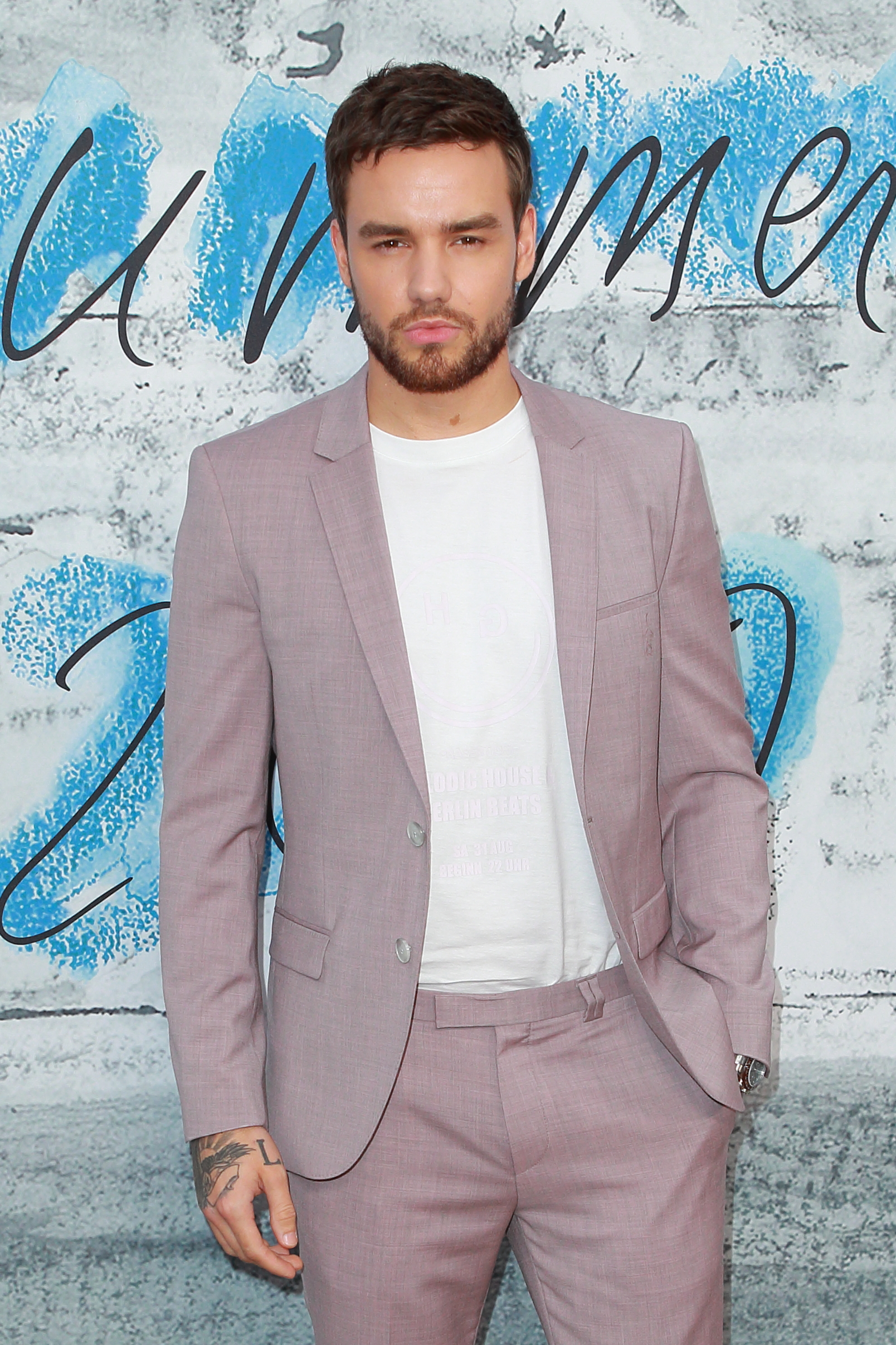 Liam Payne in a pink suit on the red carpet of a party