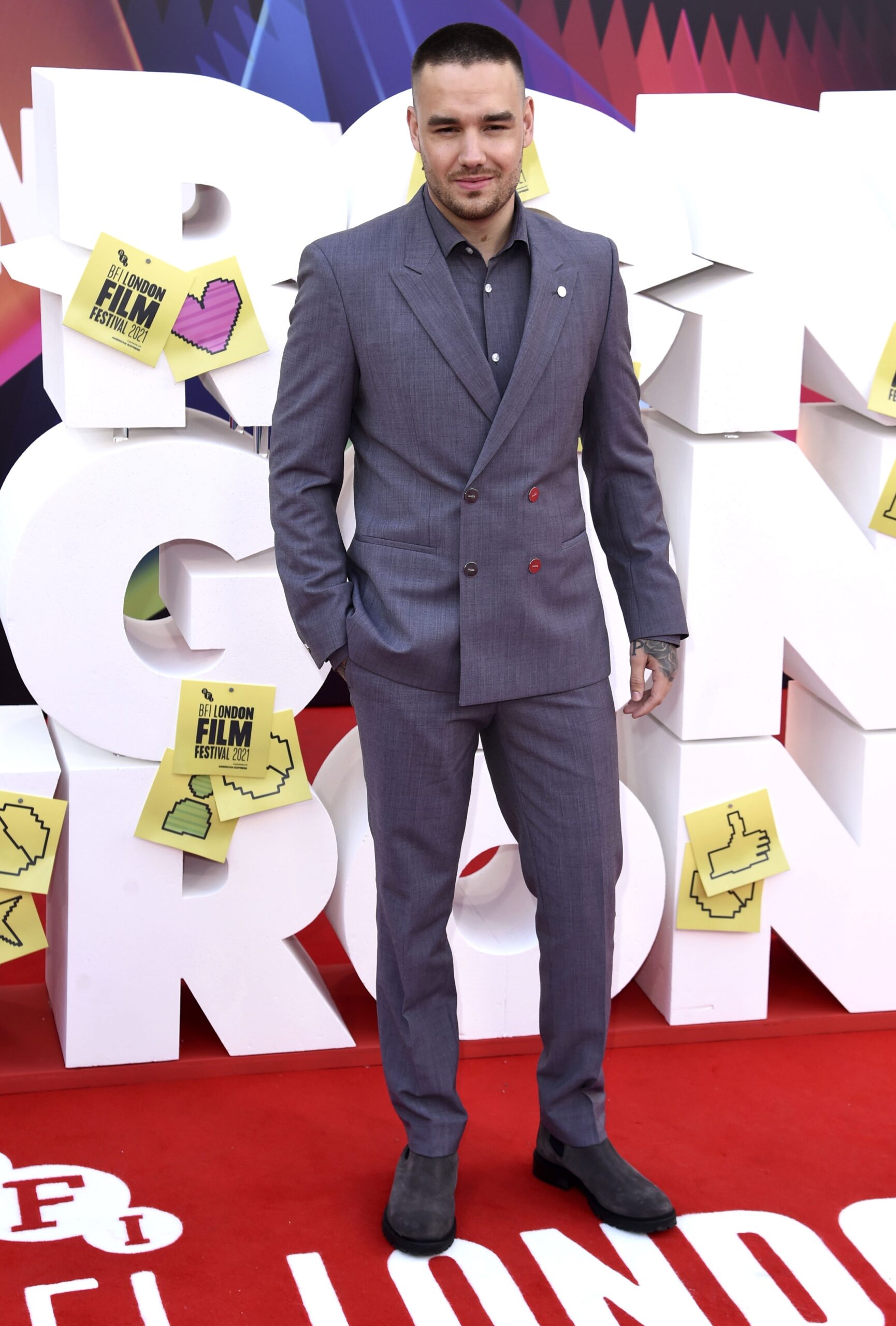 Liam Payne smiling in grey suit at event