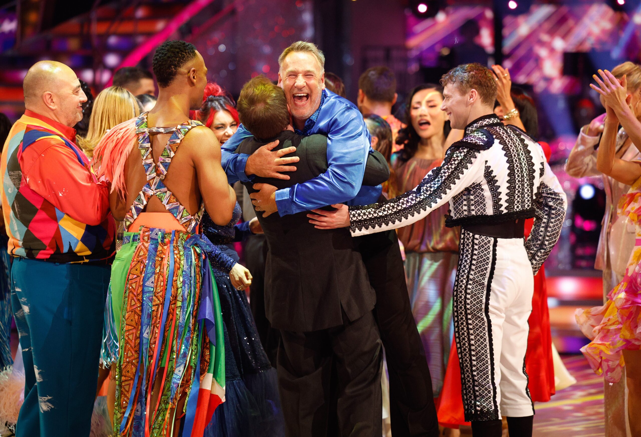 Paul Merson being hugged by Strictly stars