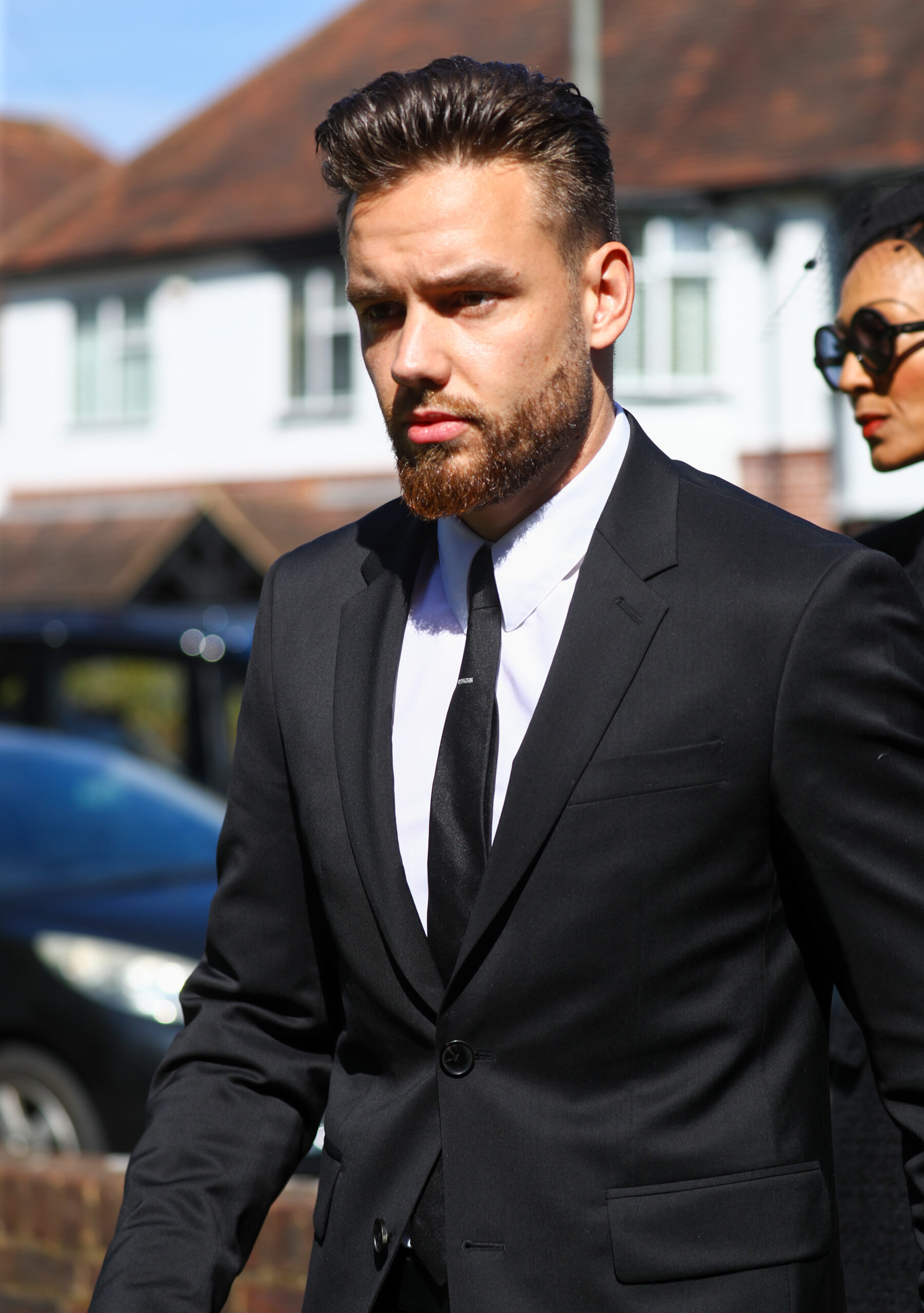 Liam Payne walking in suit