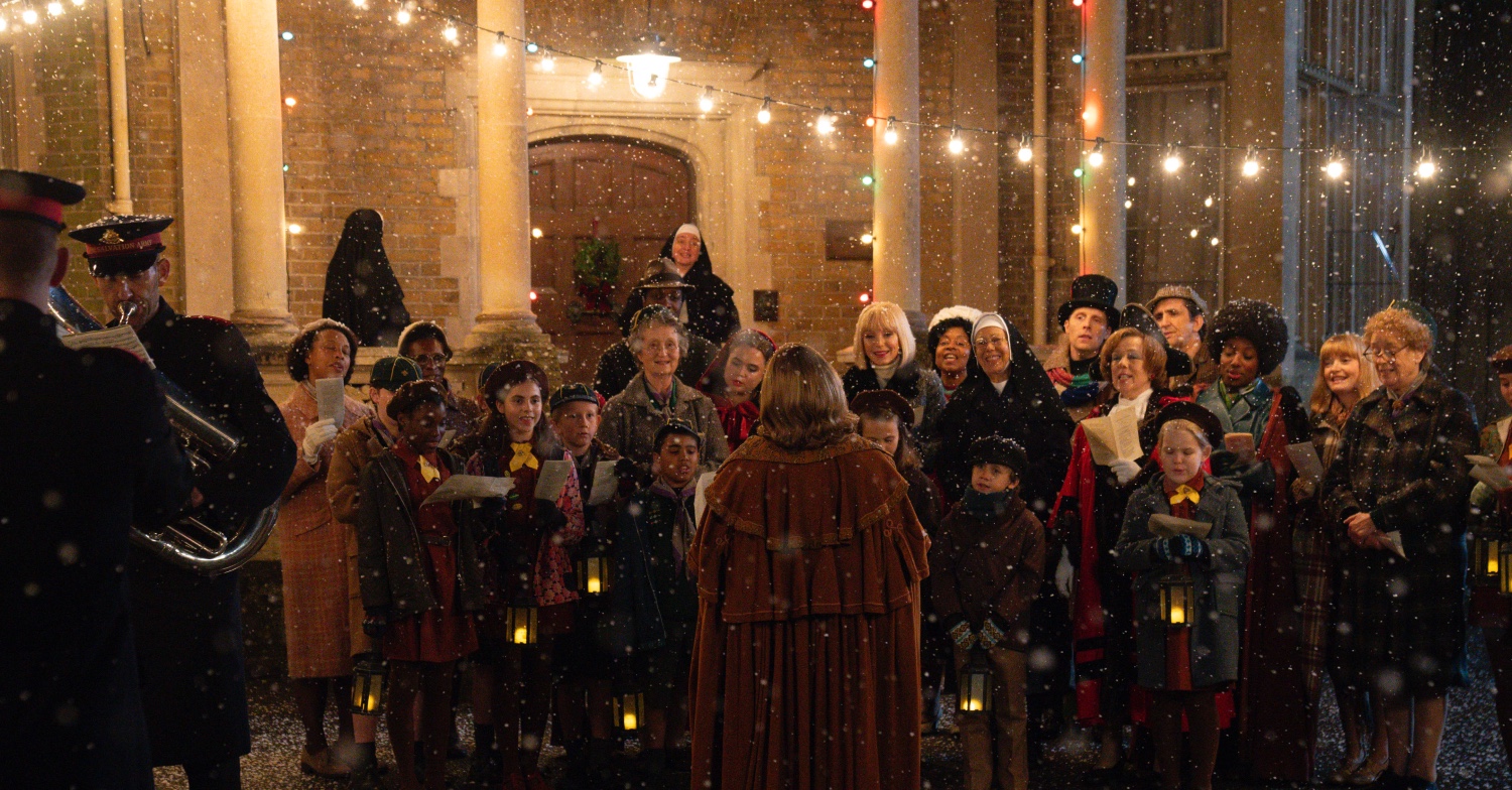Poplar neighbourhood in Call the Midwife gathering for Christmas carolling