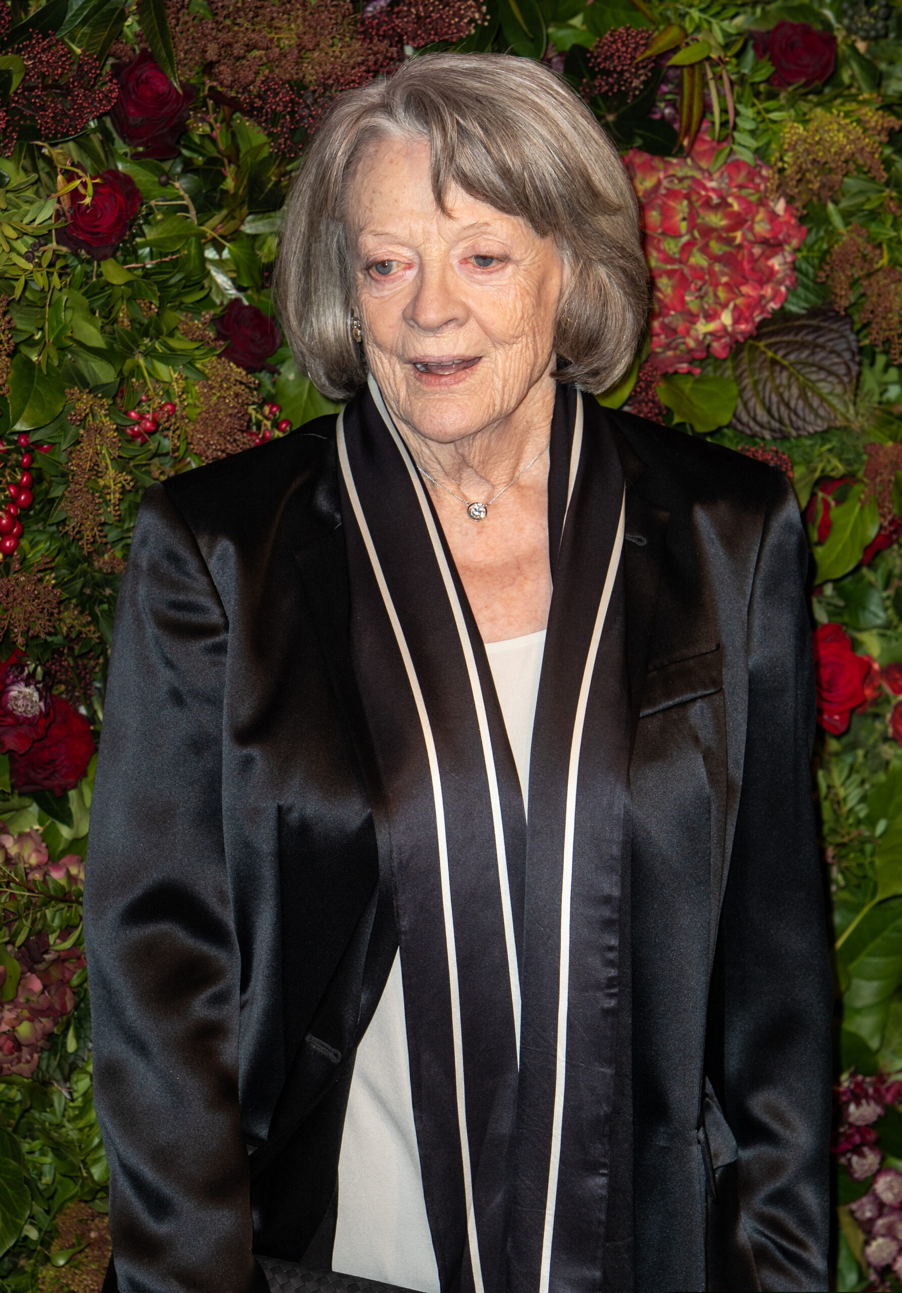 Dame Maggie Smith smiling on the red carpet