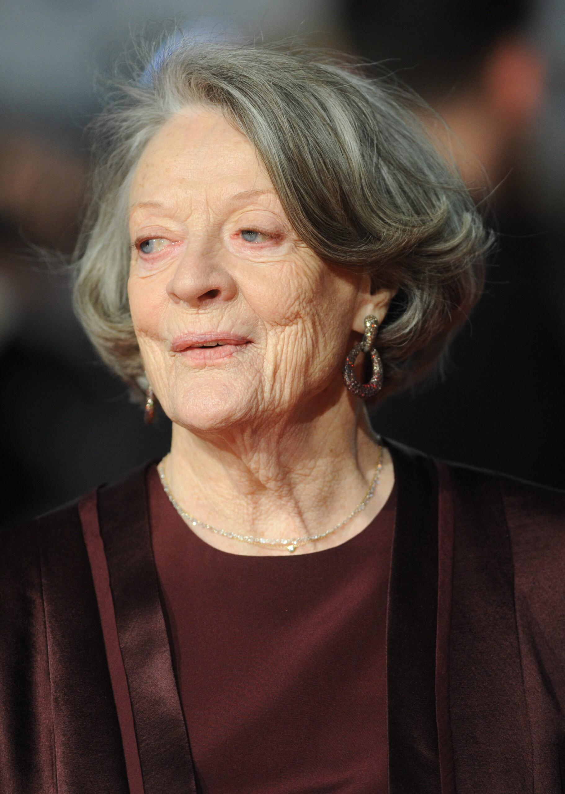 Dame Maggie Smith smiling on the red carpet