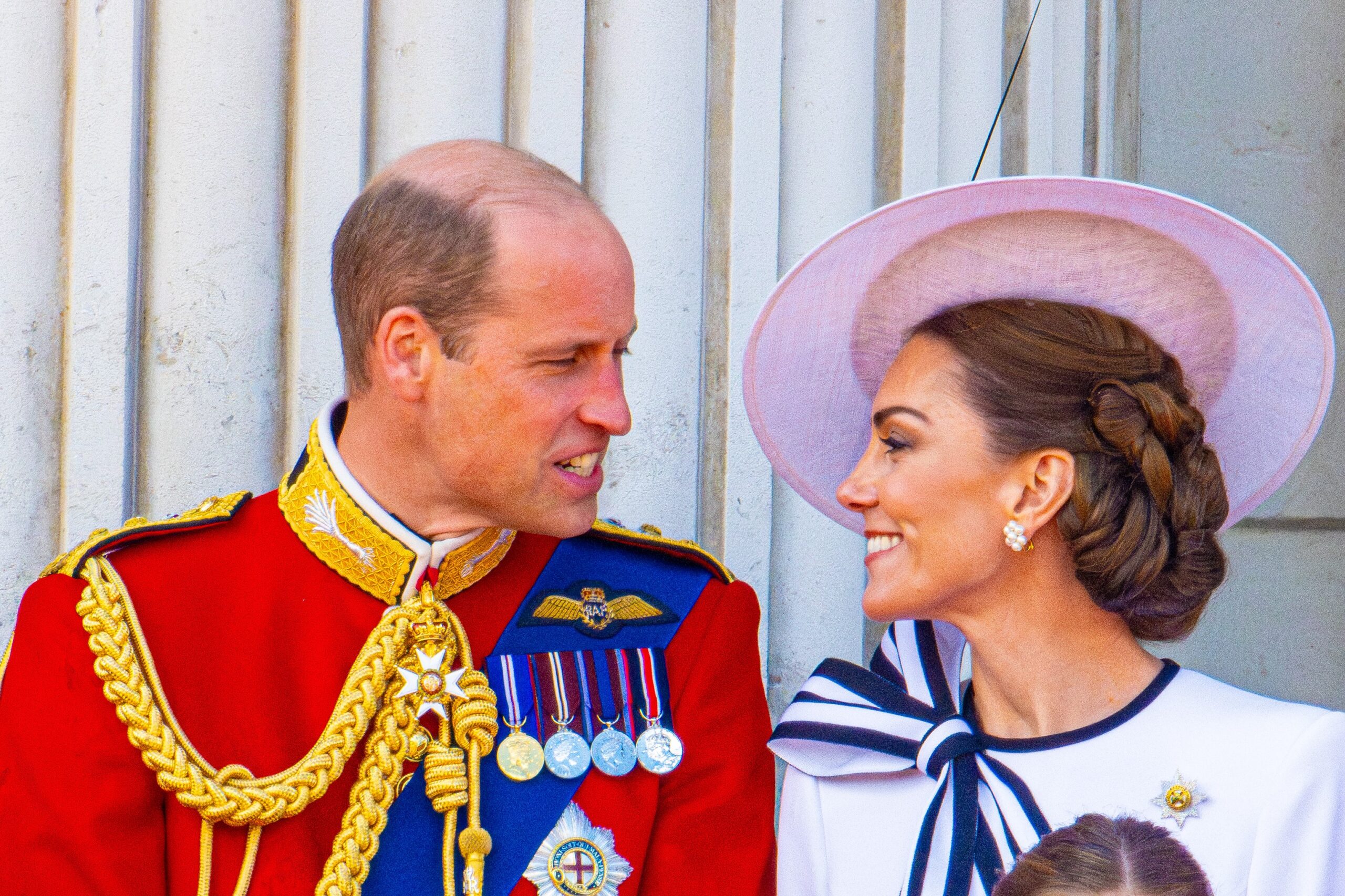 Prince William and Kate looking at each other on balcony at Trooping the Colour