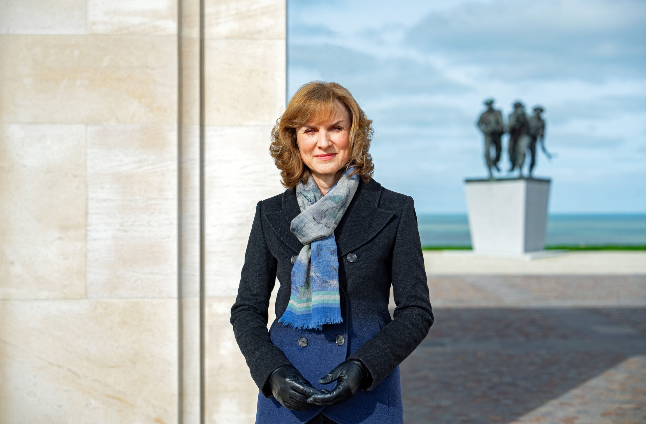 Fiona Bruce standing at a war memorial