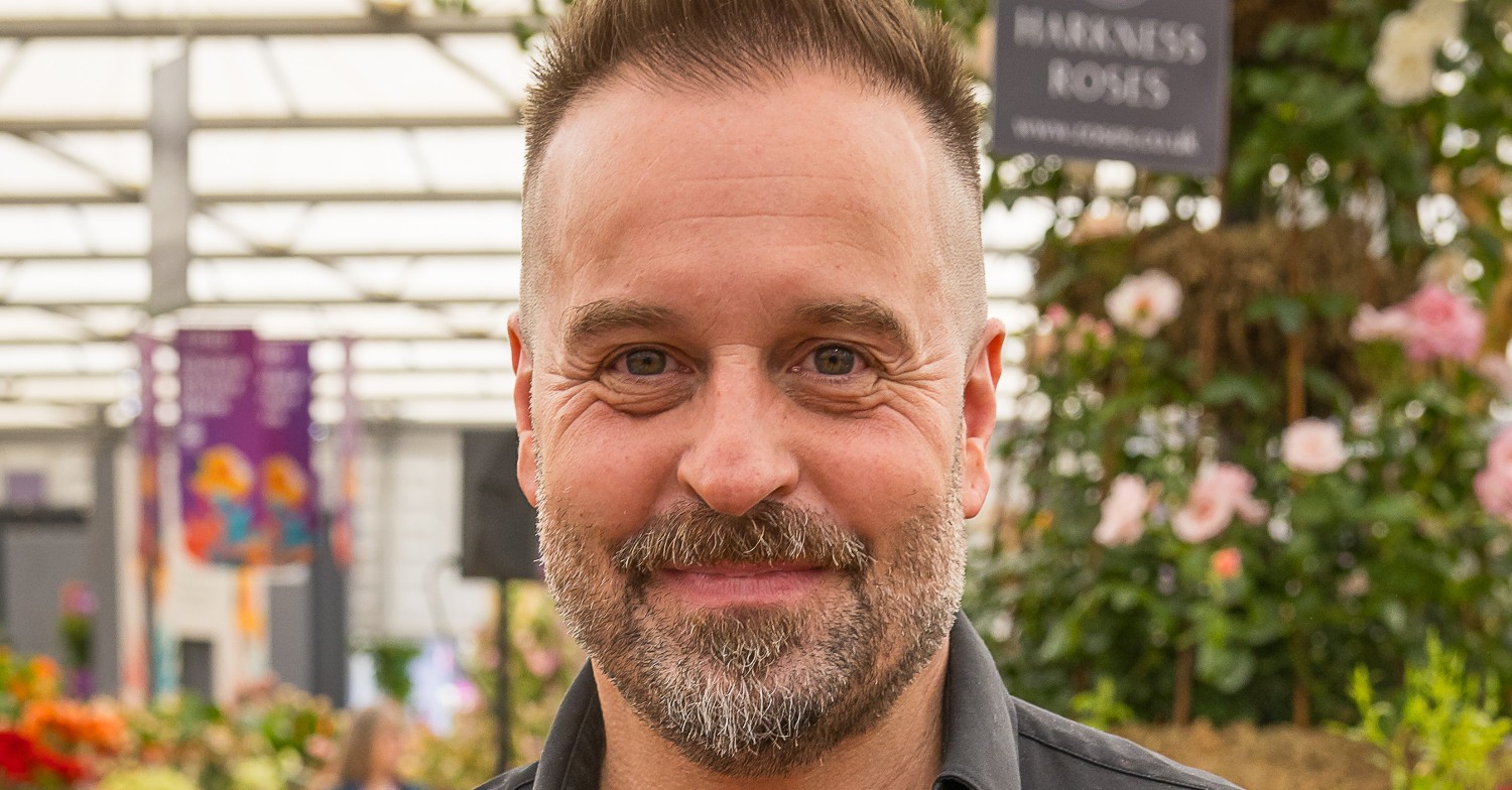 Alfie Boe at a garden centre looking to camera