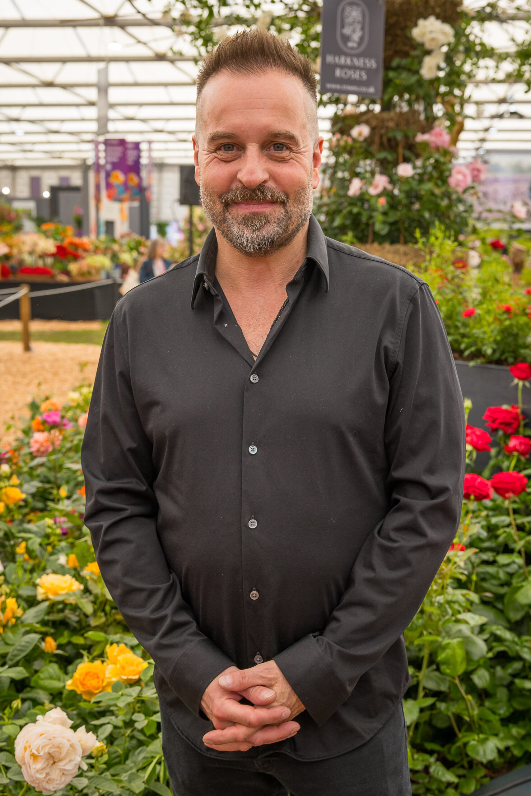 Alfie Boe at a garden centre looking to camera