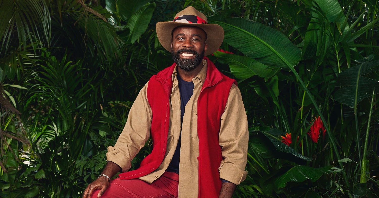 Melvin Odoom smiling in a I'm A Celeb promo shot 