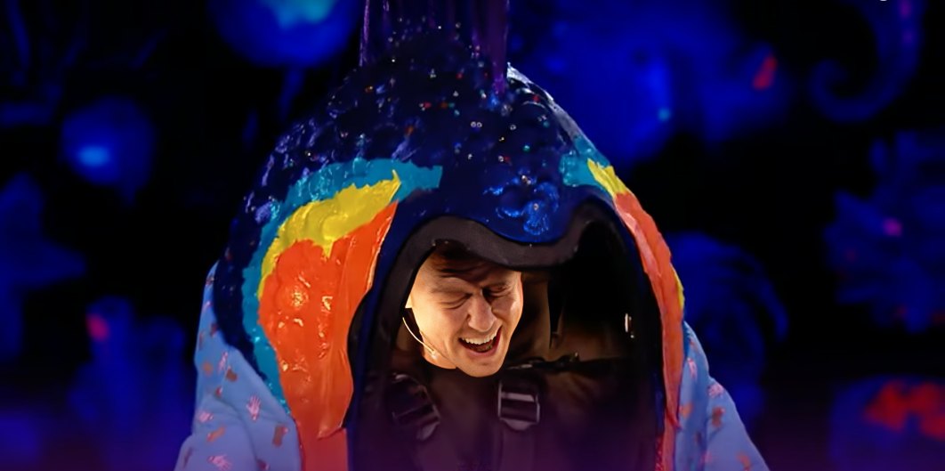 Danny Jones has his eyes closed singing while dressed in the Pirhana costume for The Masked Singer UK