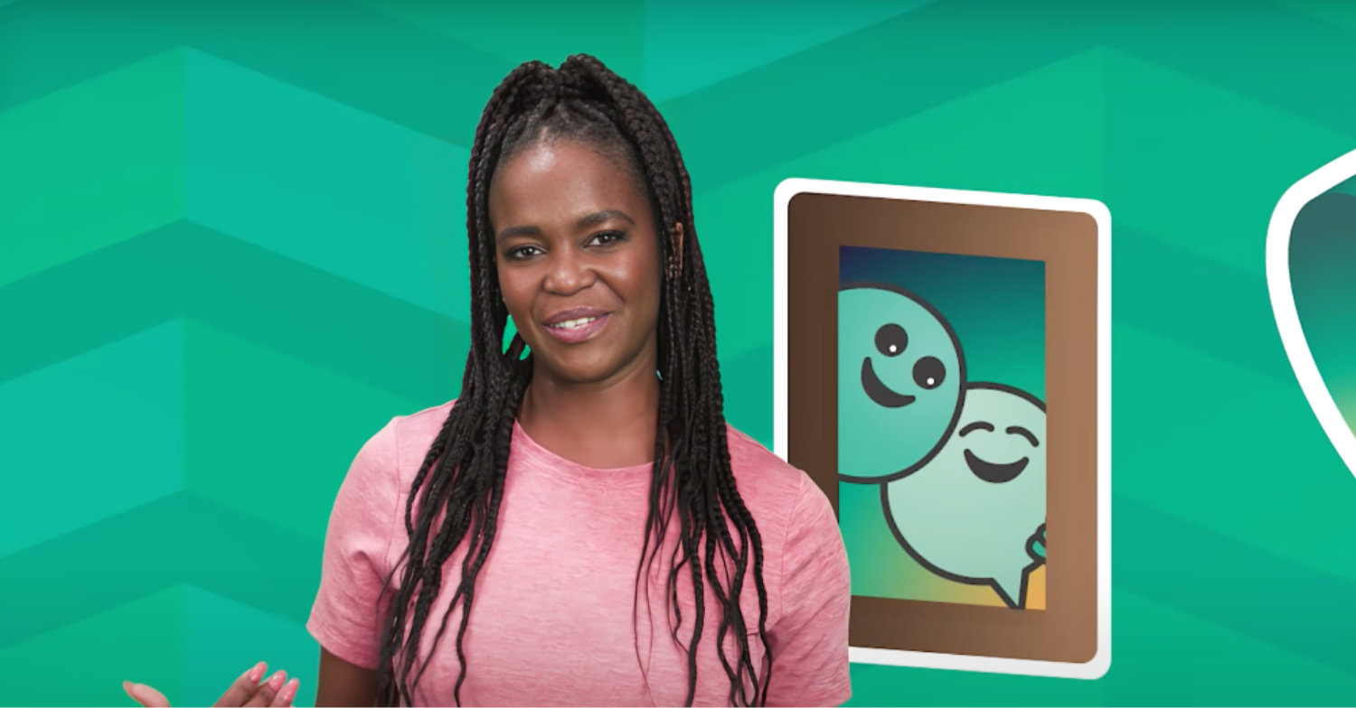 Oti Mabuse wears a pink t-shirt against a green CBeebies background
