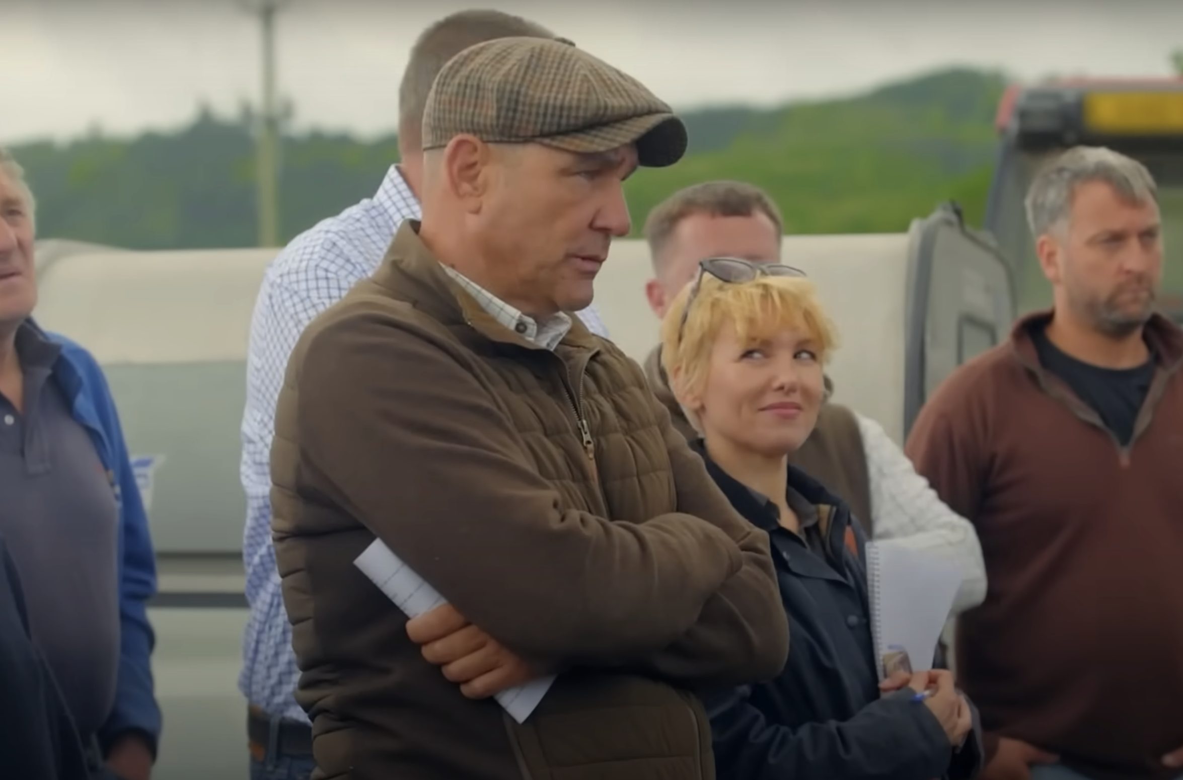 Vinnie Jones deep in concentration at a farmers' auction while his new girlfriend Emma Ford looks on