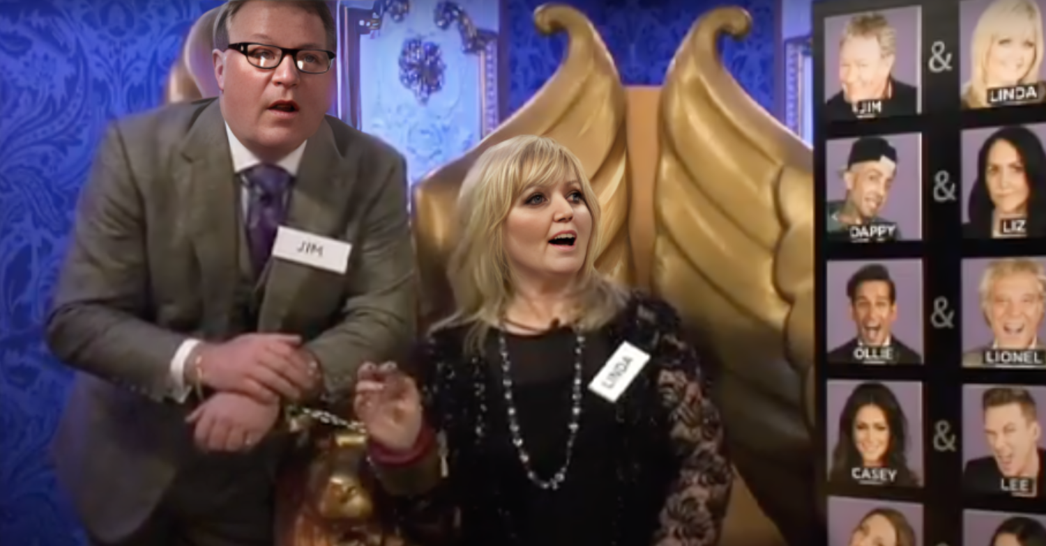 Linda Nolan sits in the Big Brother diary room looking at photos of the other contestants. Jim stands by her in a suit.
