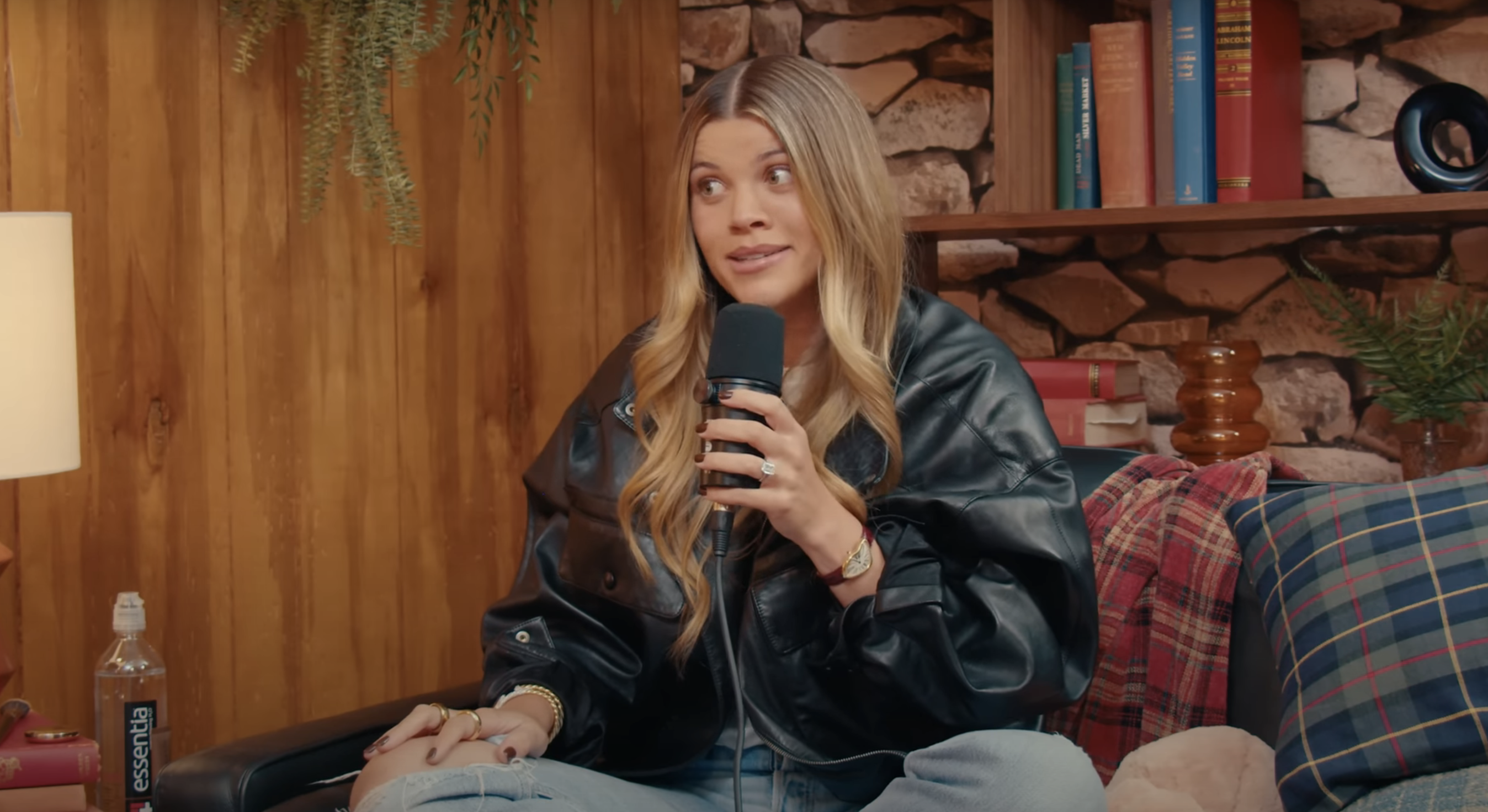 Sofia Richie speaks into a microphone during a recording of the Therapuss podcast