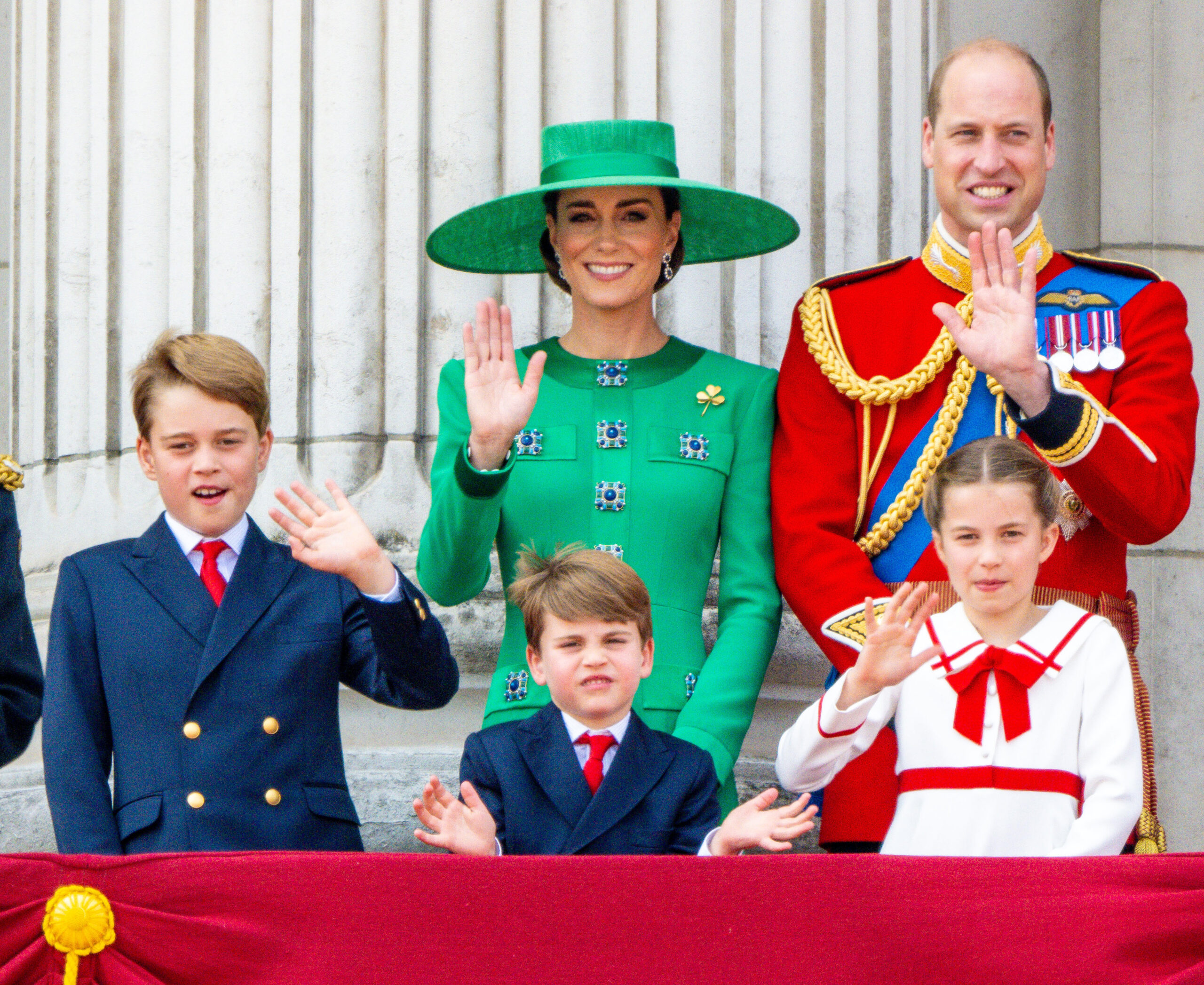 William and Kate smiling and waving with their children at Trooping the Colour