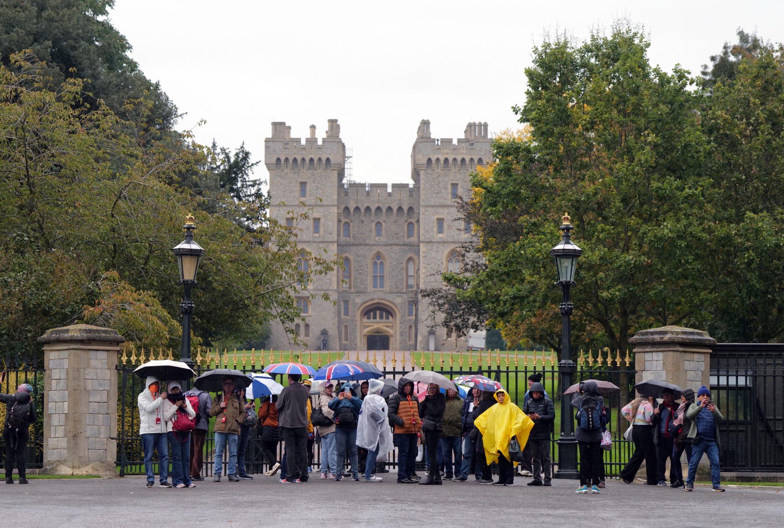 Windsor Castle from the outside as crowds stand at the gates