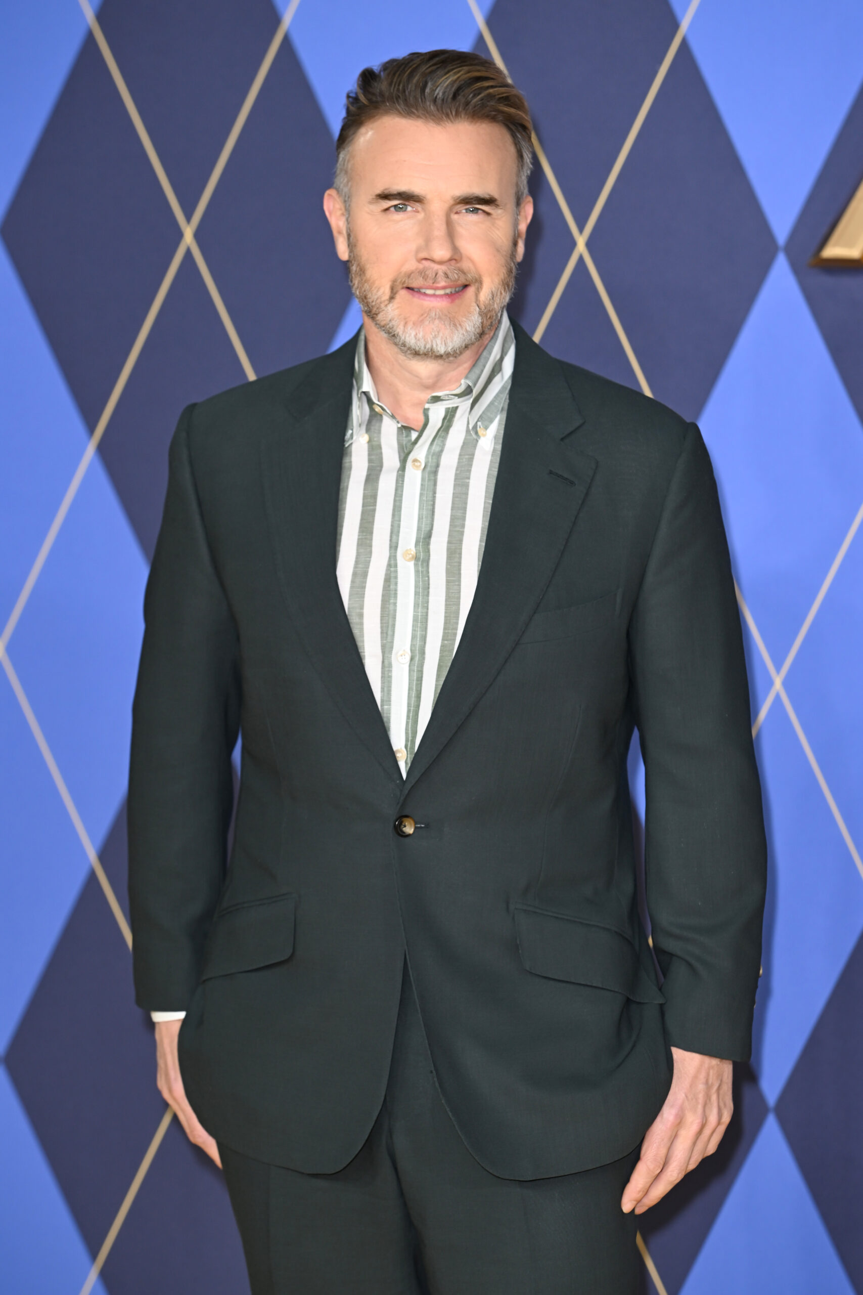 Gary Barlow smiling in suit at event