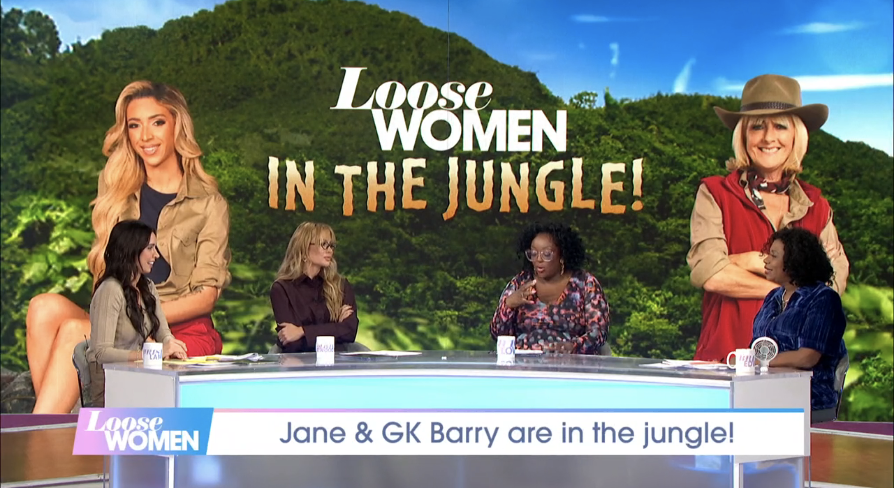 Olivia Attwood and the other Loose Women panellists in front of an I'm A Celebrity banner