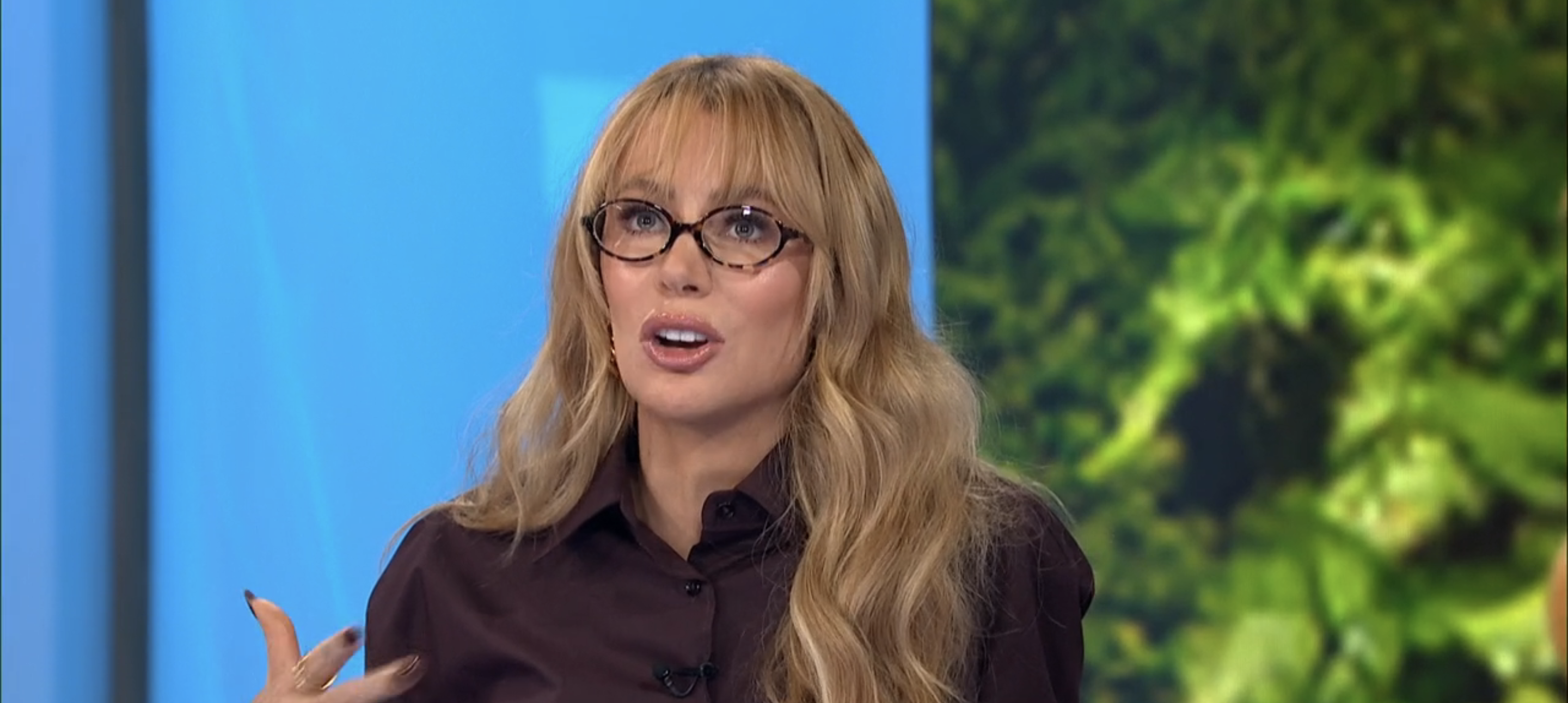 Olivia Attwood in a dark shirt and thick-rimmed glasses on Loose Women