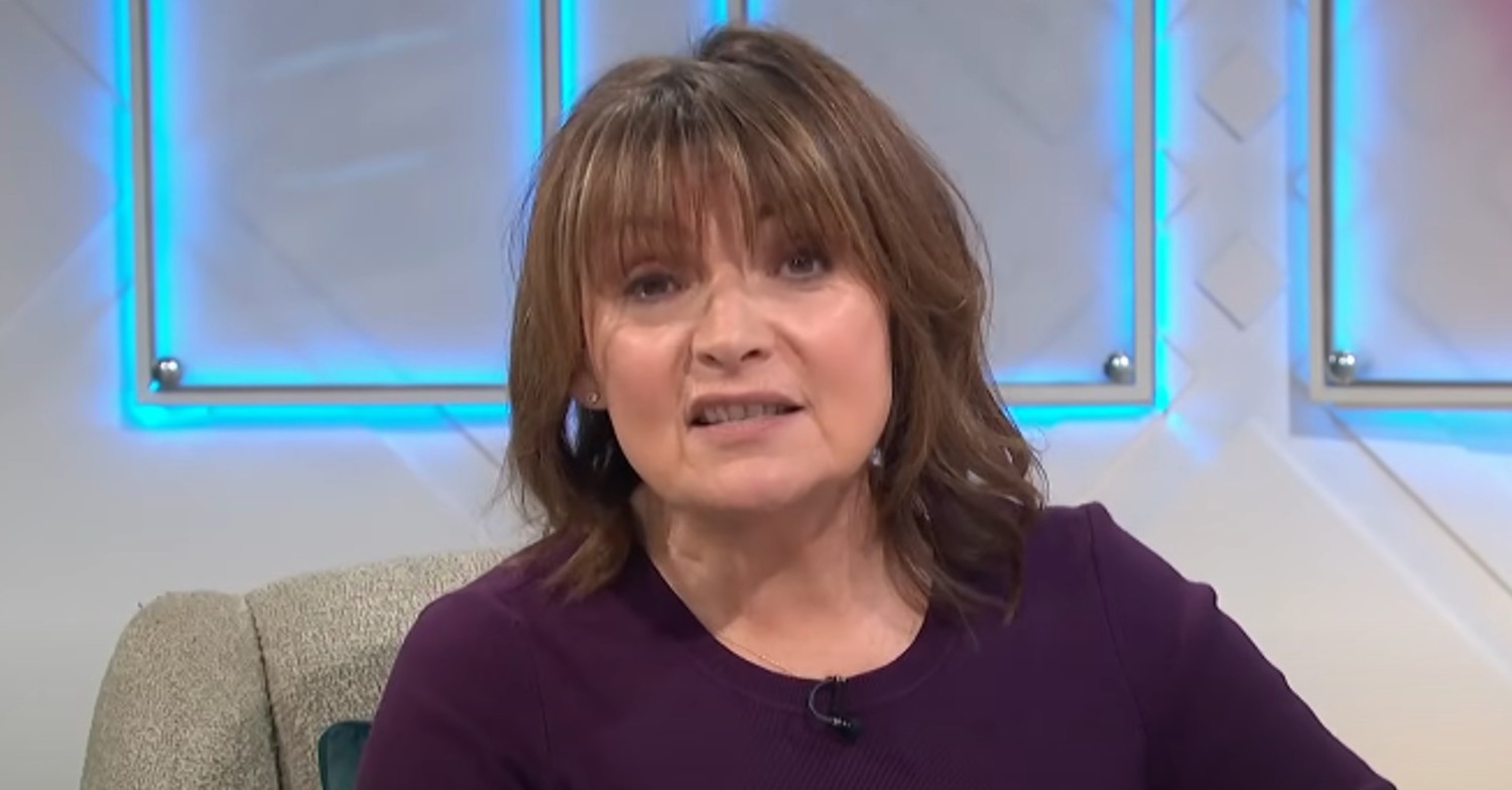 Lorraine Kelly in purple talking to viewers on ITV show