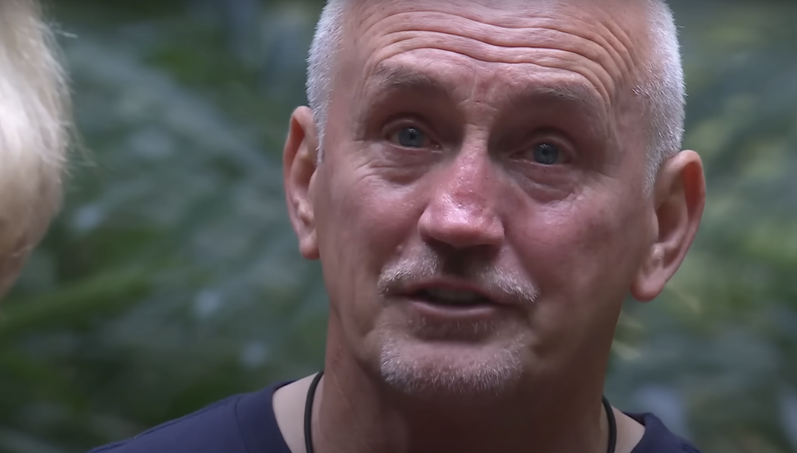 Barry McGuigan looks past the camera with tears in his eyes in the I'm A Celebrity jungle