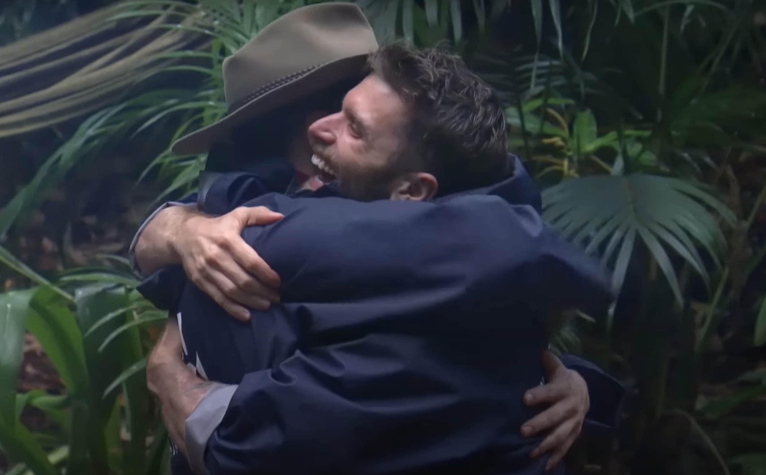 Joel Dommett embraces one of his campmates on I'm A Celebrity in 2016