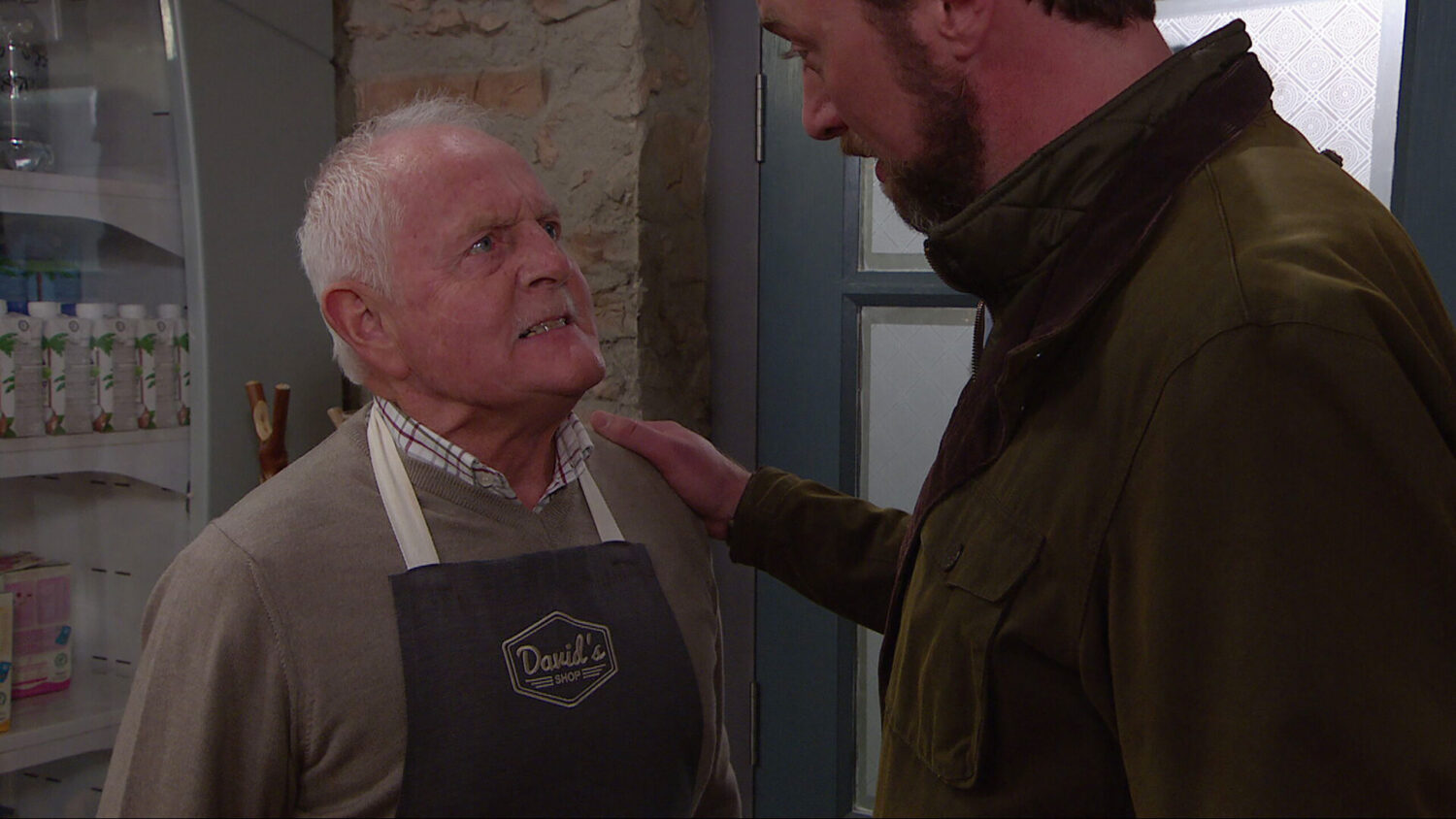 Eric talking to Liam in the shop on Emmerdale