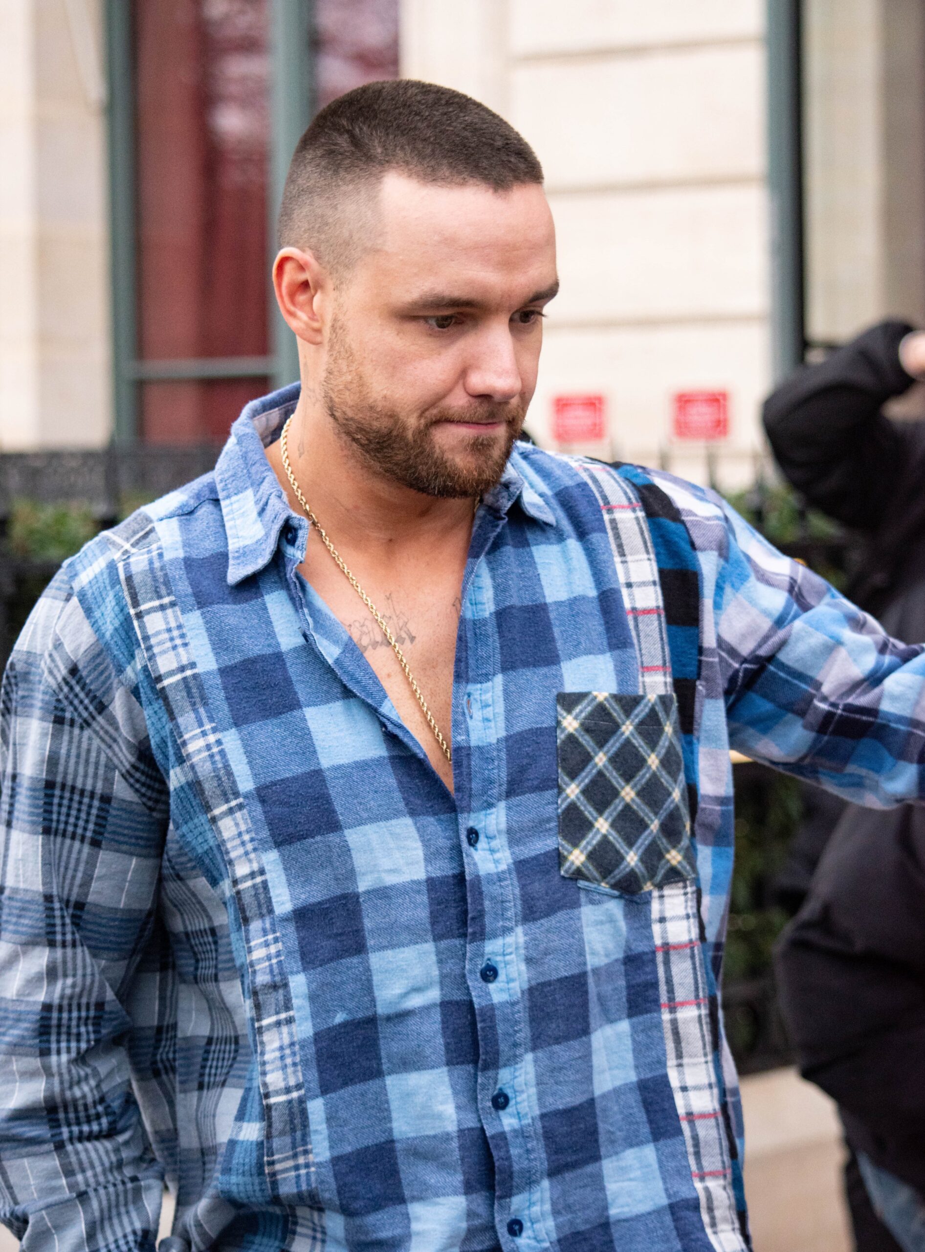 Liam Payne meeting fans in blue checkered shirt