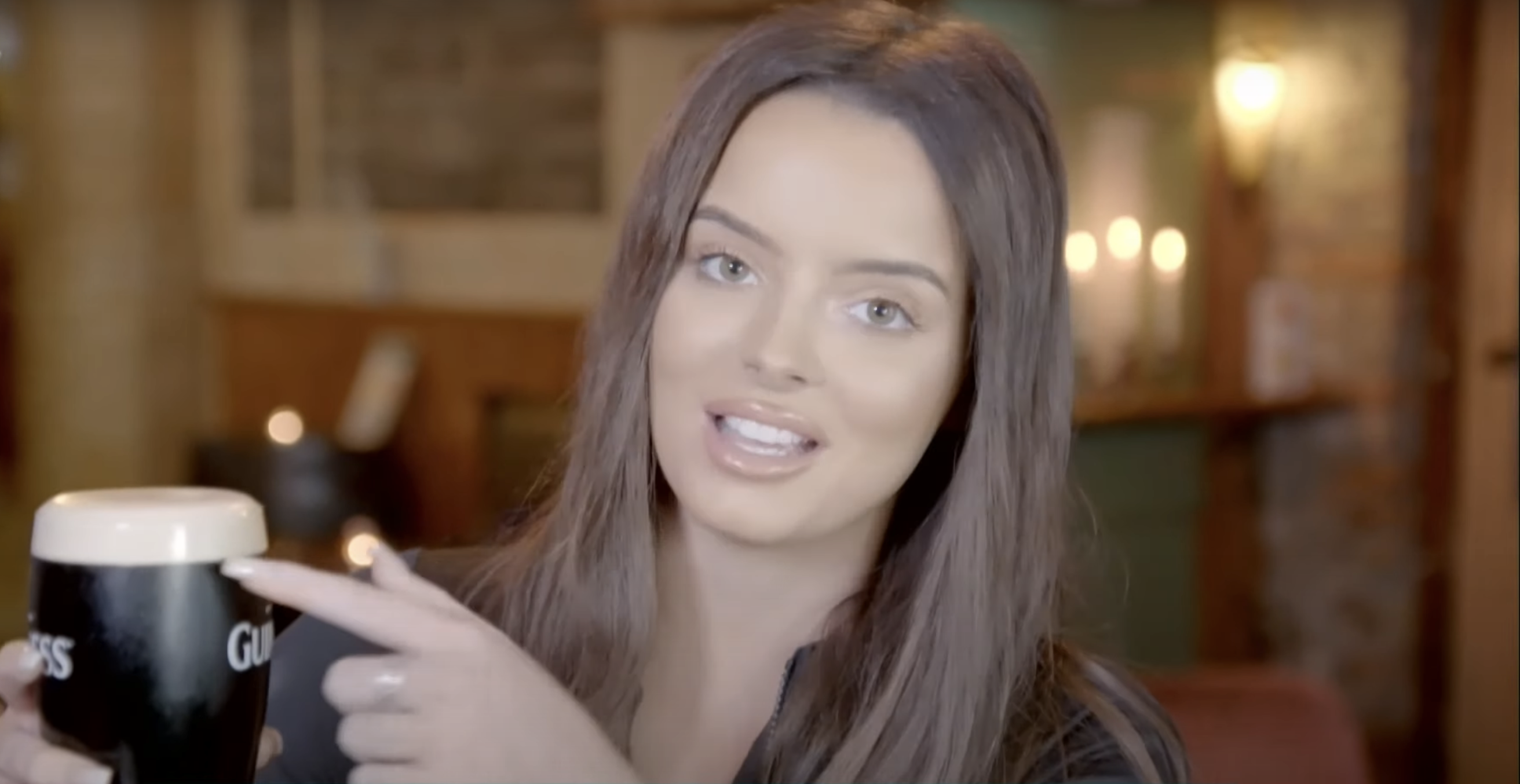 Maura Higgins holding up a glass of Guinness