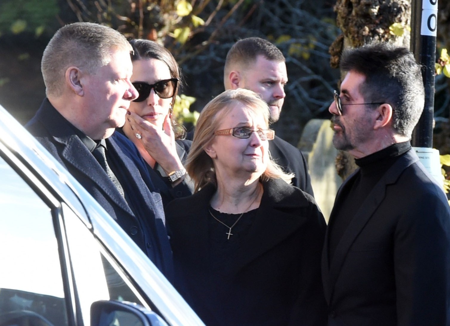 Simon Cowell talking to Liam Payne's parents at funeral