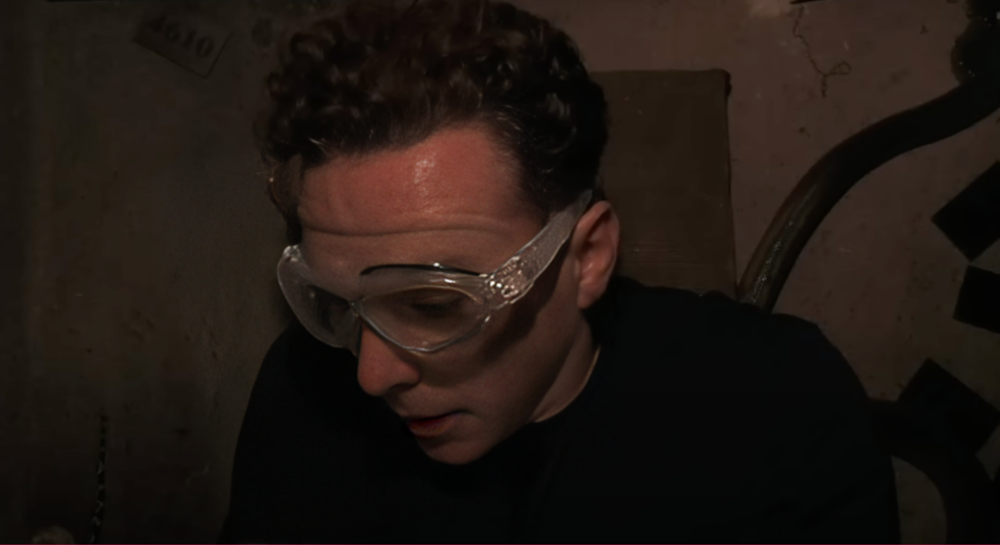 Danny Jones is wearing safety goggles trapped in a dark box in a I'm a Celebrity Bush Tucker challenge.
