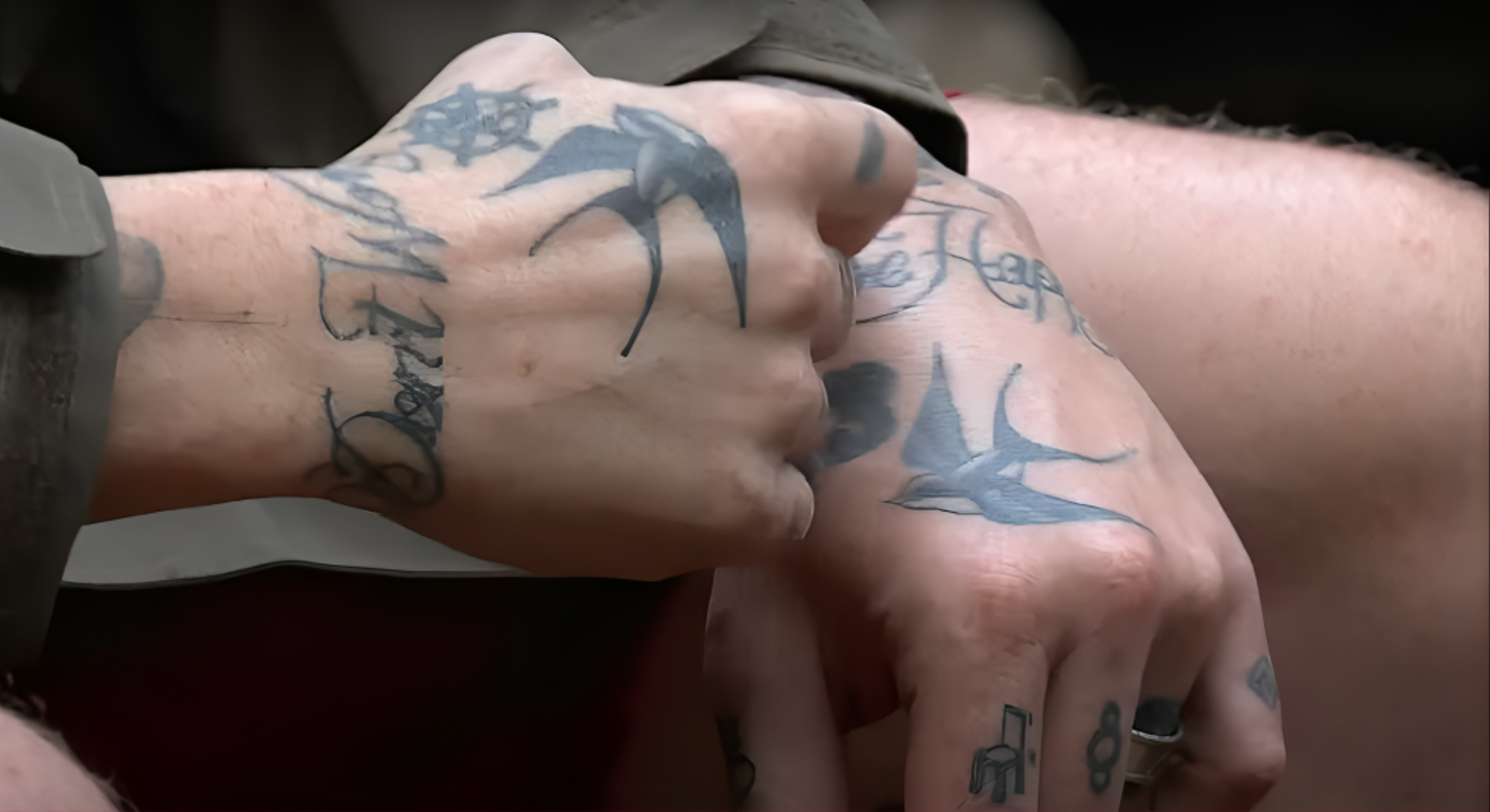 Close-up of Danny Jones' hands showing his Don't Worry Be Happy tattoo