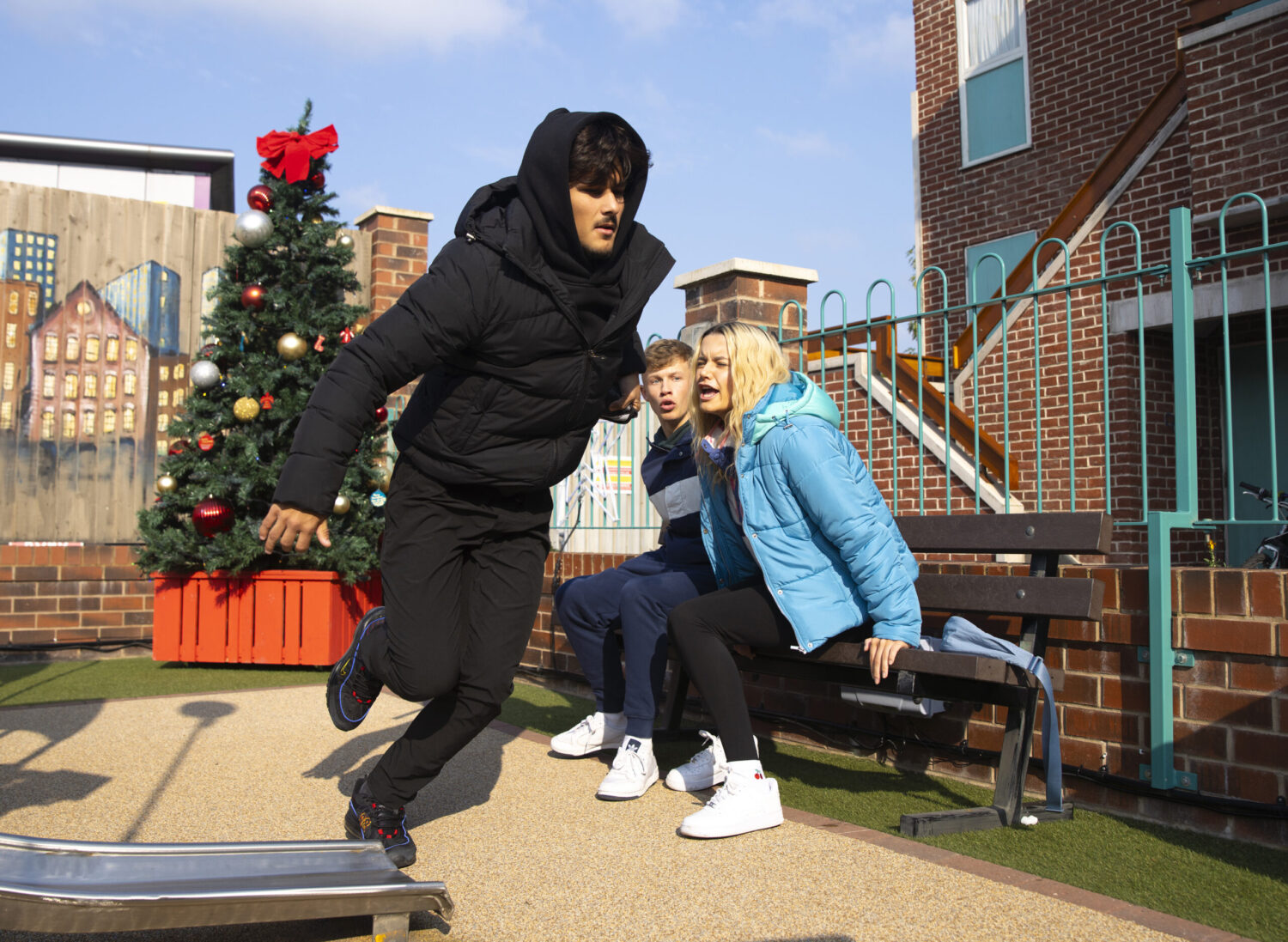 A lad running from a frightened Betsy and Dylan at the precinct