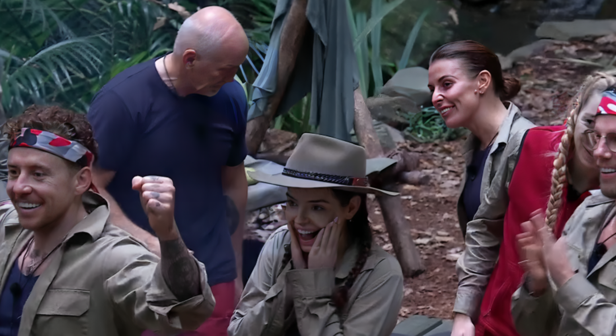 Maura Higgins holds her face in surprise as the celebrities sing happy birthday and she awaits her gift on I'm A Celebrity