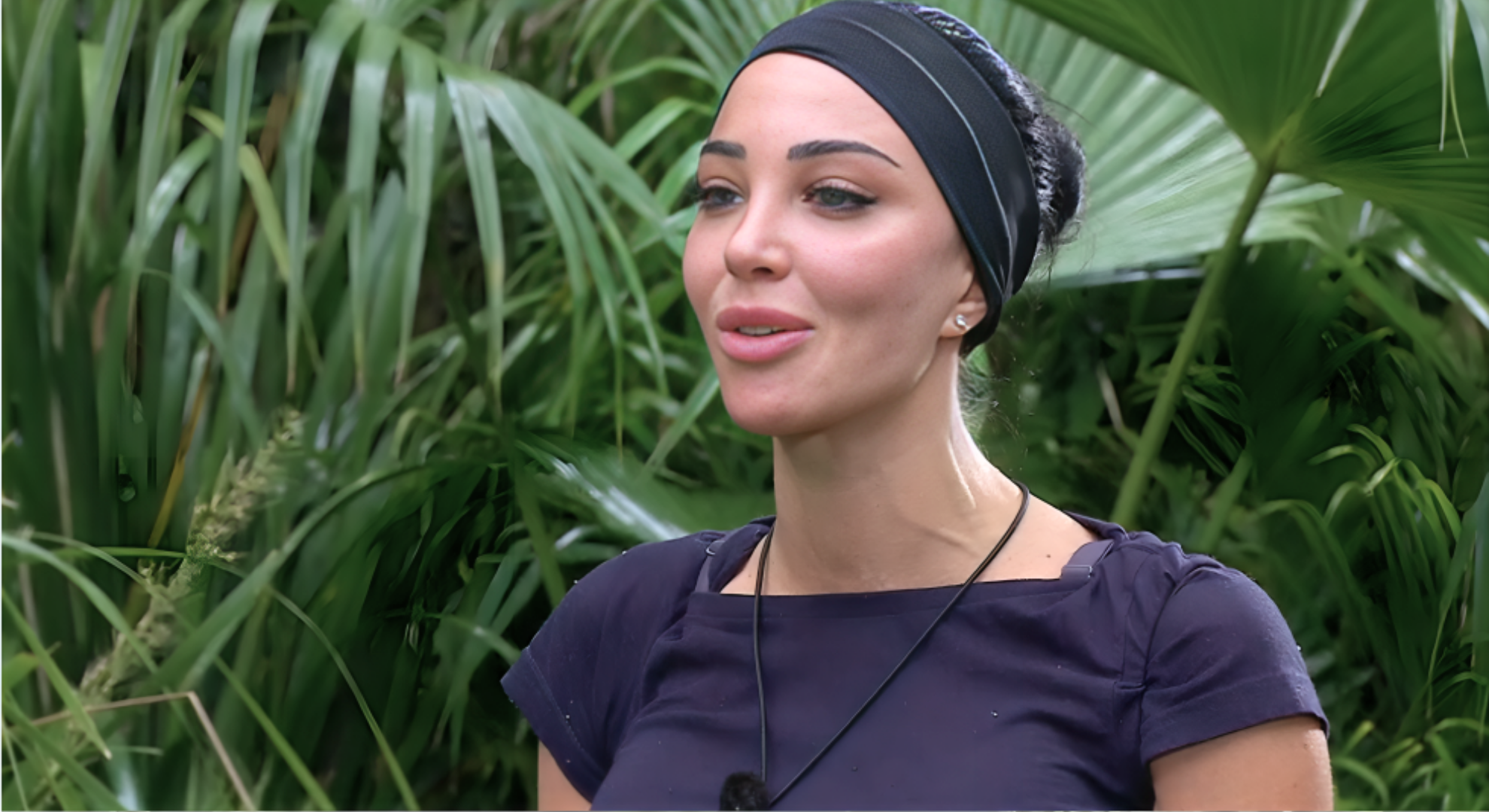 Tulisa Contostavlos is wearing a black headband and talking to Ant and Dec (offscreen) during her trial.