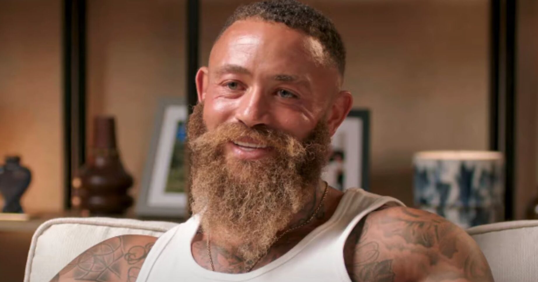 Ashley Cain smiling in podcast interview