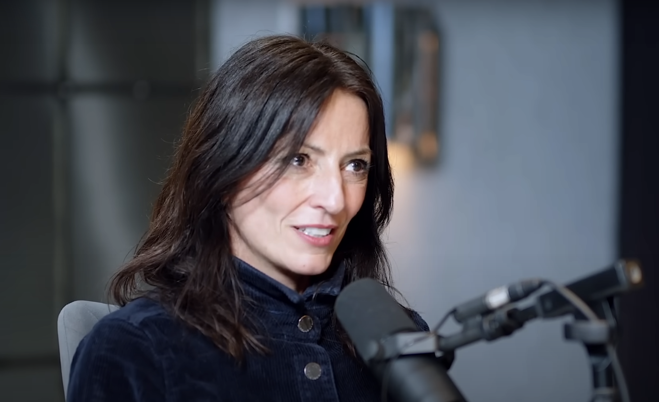 Davina McCall on The Diary Of A CEO podcast, speaking into a microphone