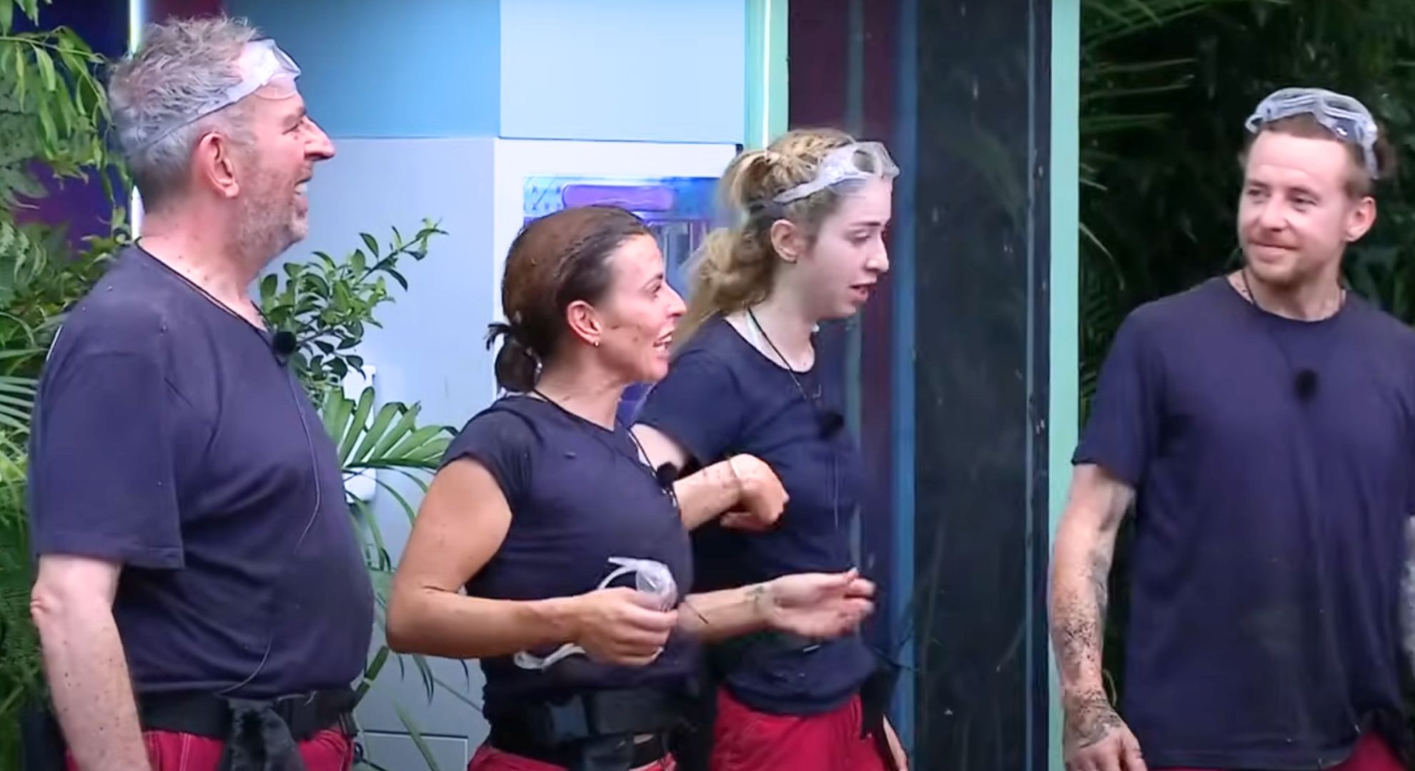 Coleen Rooney looks relieved after having a critter removed from her ear while her campmates Danny, GK Barry and Rev Richard look at her 