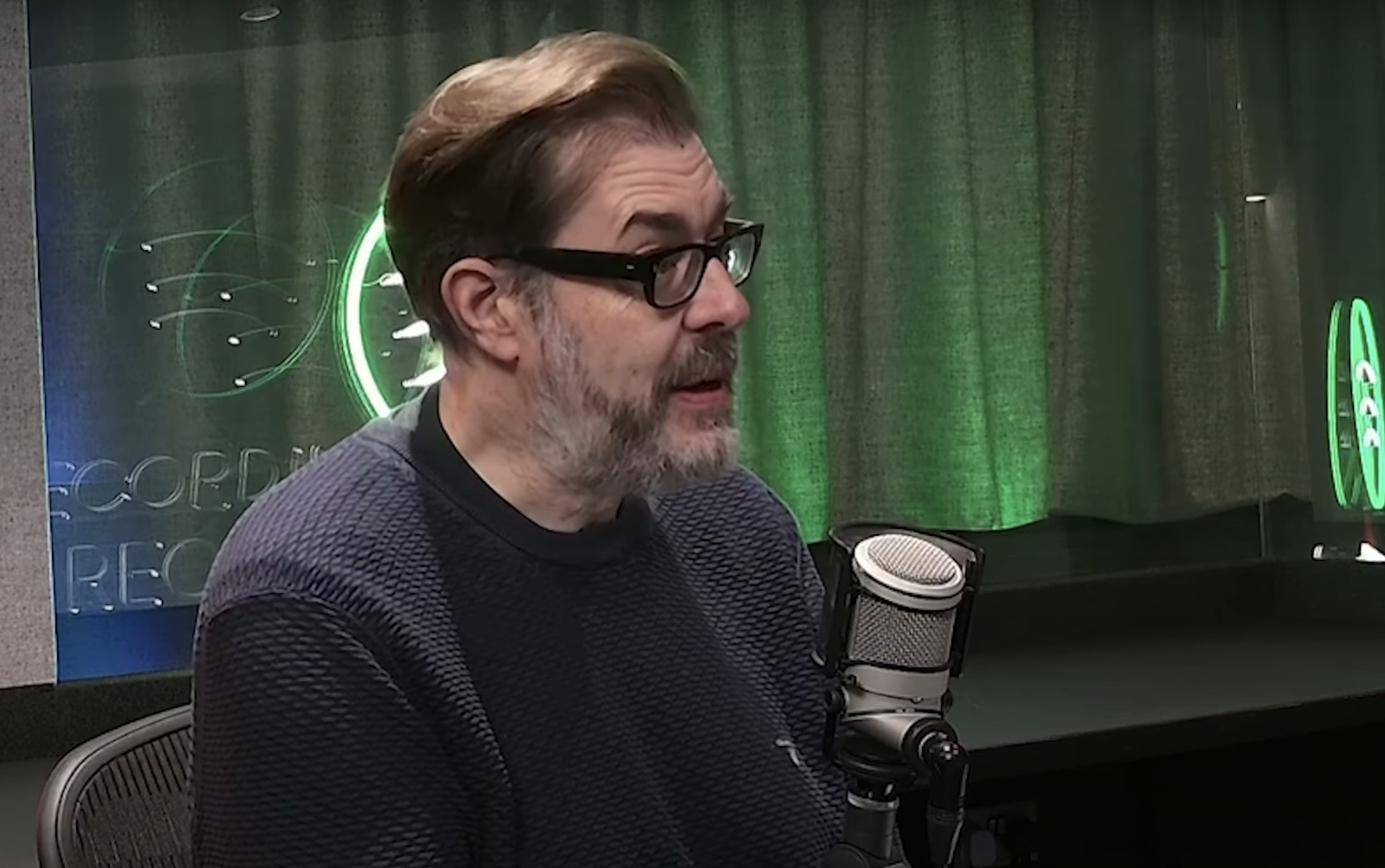 Richard Osman recording The Rest Is Entertainment in the studio