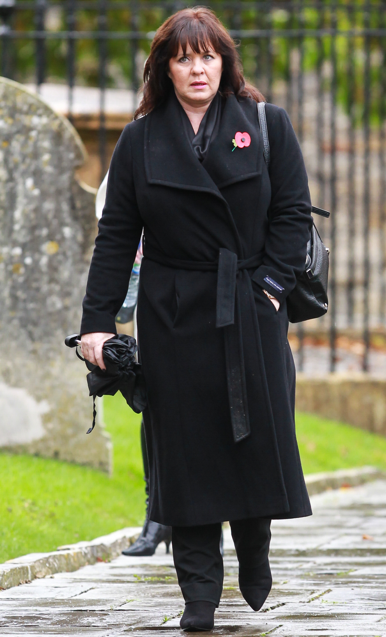 Coleen Nolan looking sad in a black coat
