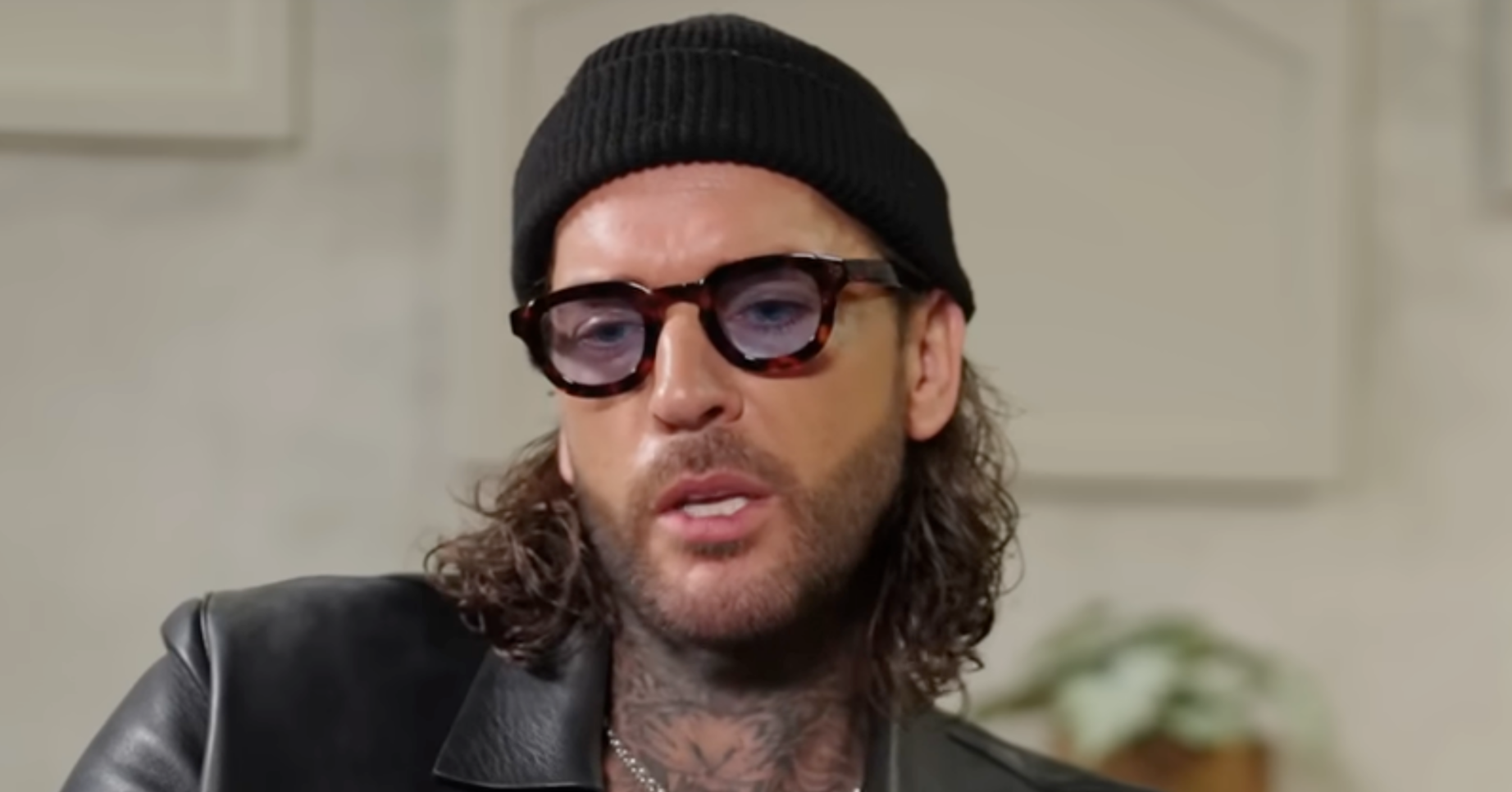 Pete Wicks wearing a hat speaking on a podcast