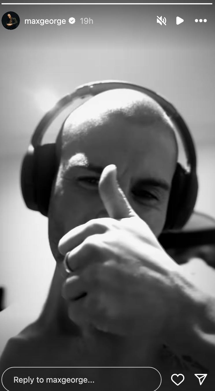 Max George giving a thumbs up wearing headphones