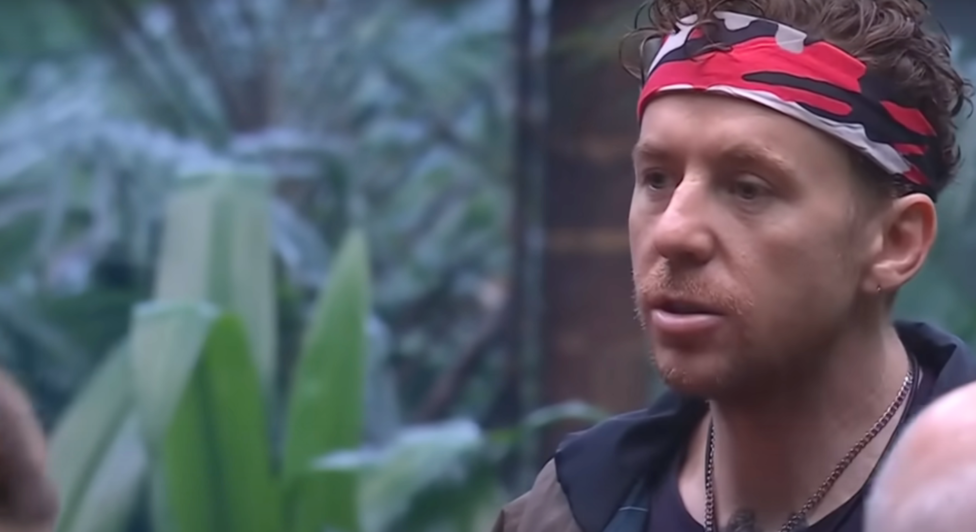 Danny Jones checks on his campmates after heavy rainfall 