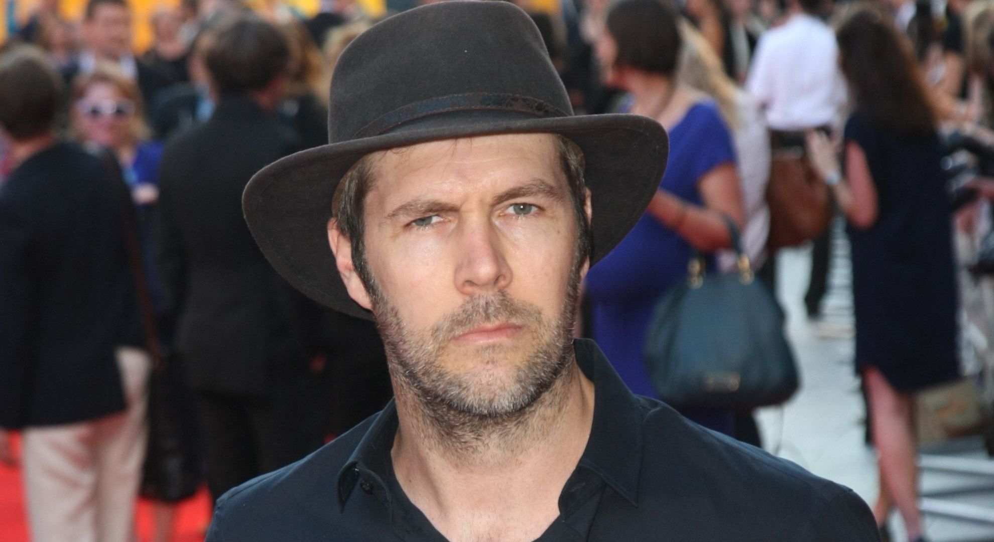 Rhod Gilbert frowning wearing a hat