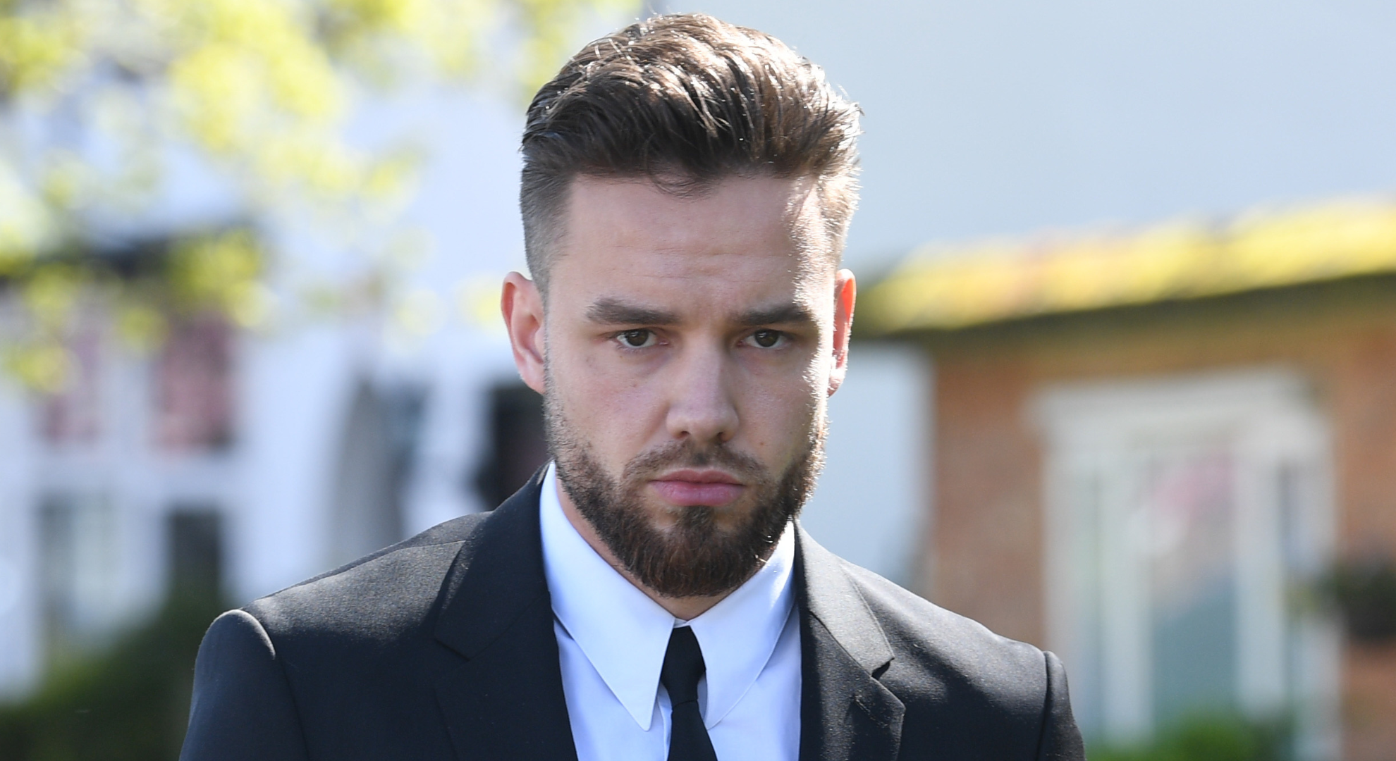 Liam Payne frowning wearing a suit 