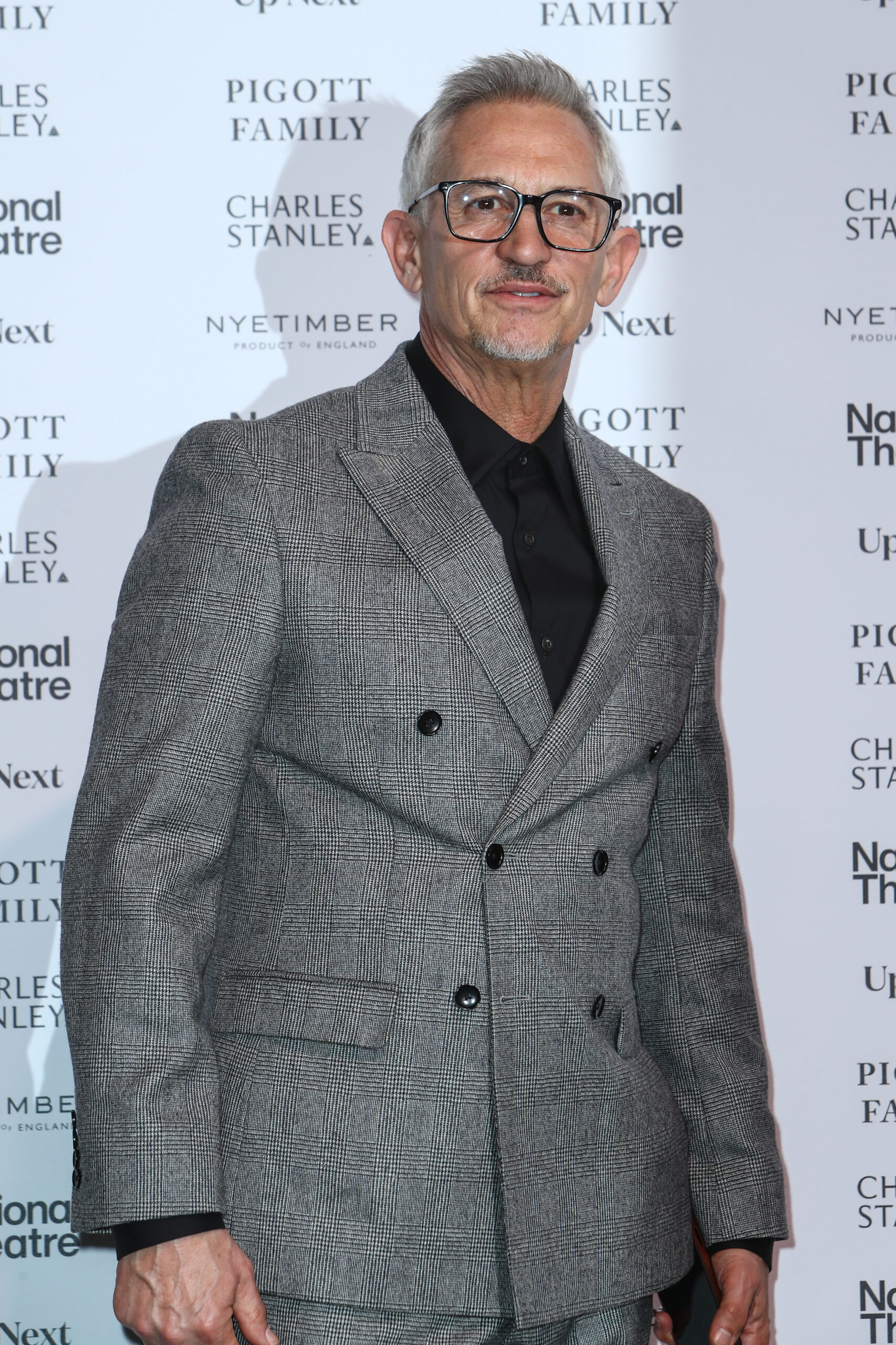 Gary Lineker in a grey suit as he poses for the camera