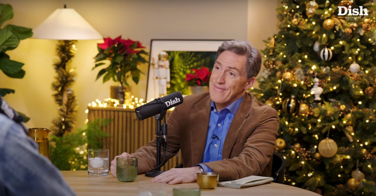Rob Brydon sitting in a podcast