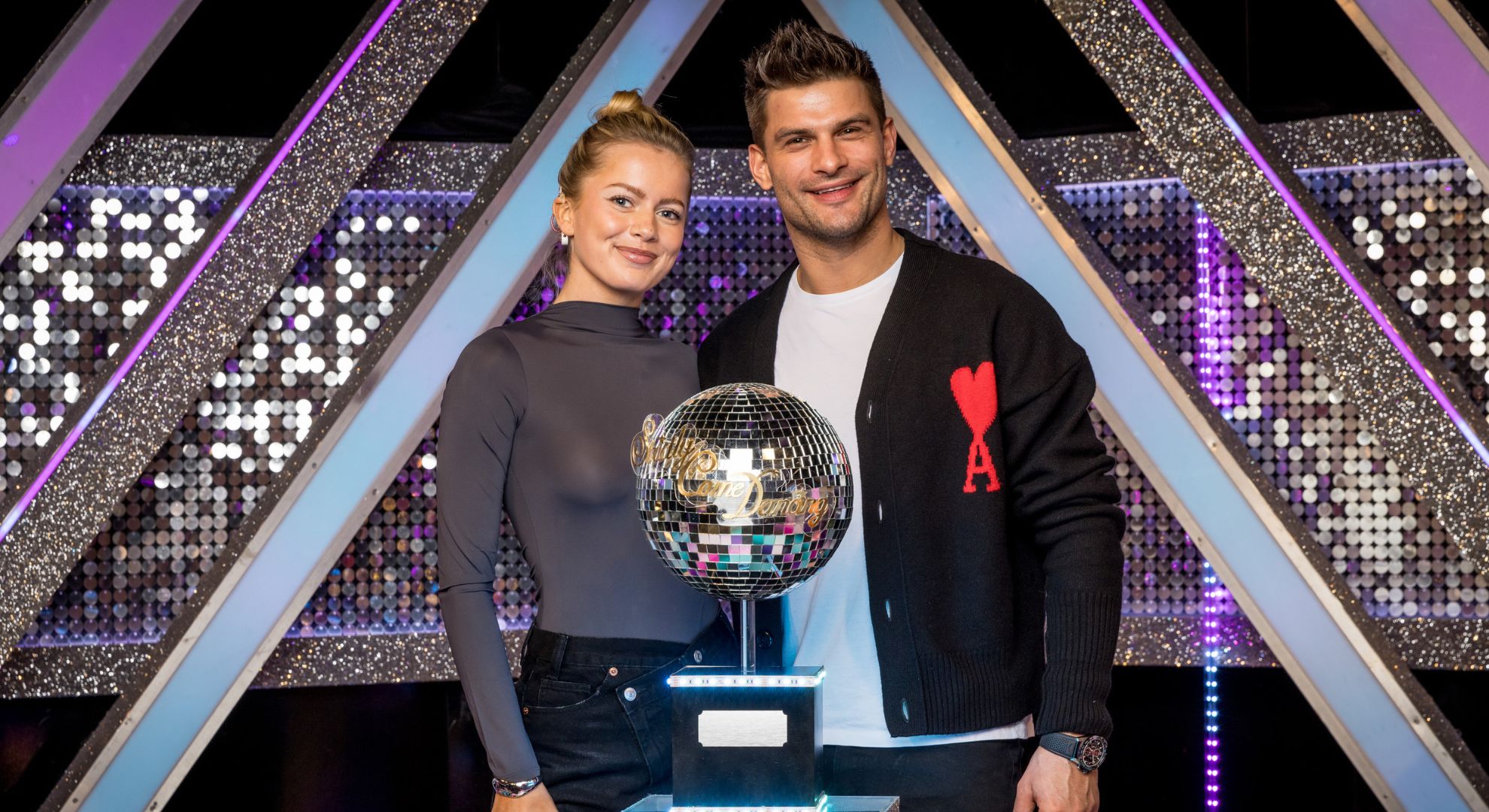 Tasha Ghouri and Aljaz Skorjanec posing with the Glitterball Trophy