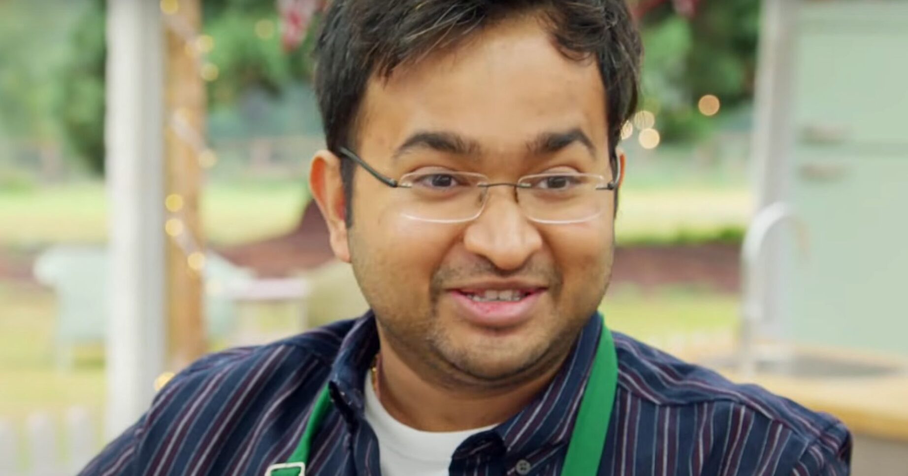 Rahul Mandal talking to the judges on Great British Bake Off